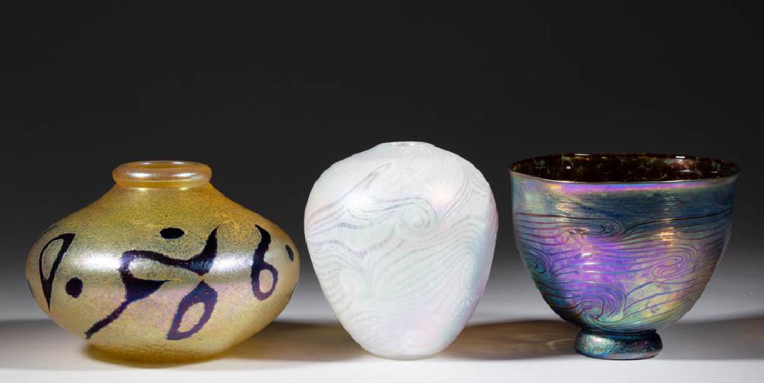 ASSORTED IRIDESCENT STUDIO ART GLASS ARTICLES, LOT OF: ASSORTED IRIDESCENT STUDIO ART GLASS ARTICLES, LOT OF THREE, comprising a signed Orient & Flume golden iridescent with amethyst decoration compressed vase, an ovoid rainbow iridescent with opal decora