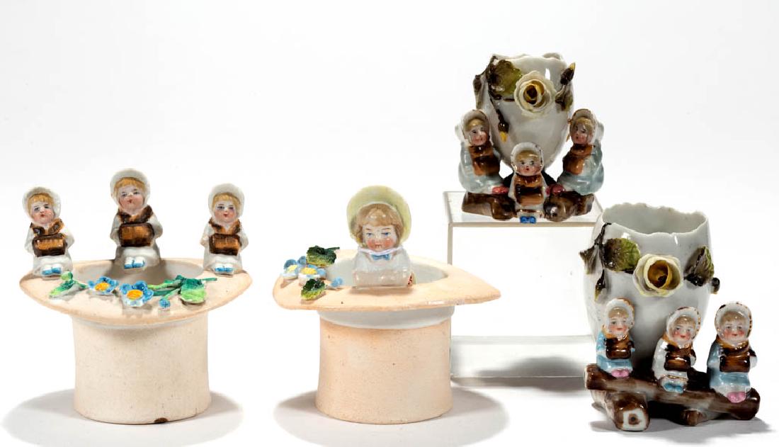 GERMAN PORCELAIN KATE GREENAWAY FIGURAL TOOTHPICK: GERMAN PORCELAIN KATE GREENAWAY FIGURAL TOOTHPICK HOLDERS, LOT OF FOUR, two with bisque finish, comprising two egg-form examples marked for Conta & Boehme, and unmarked two hat-form examples, each wit