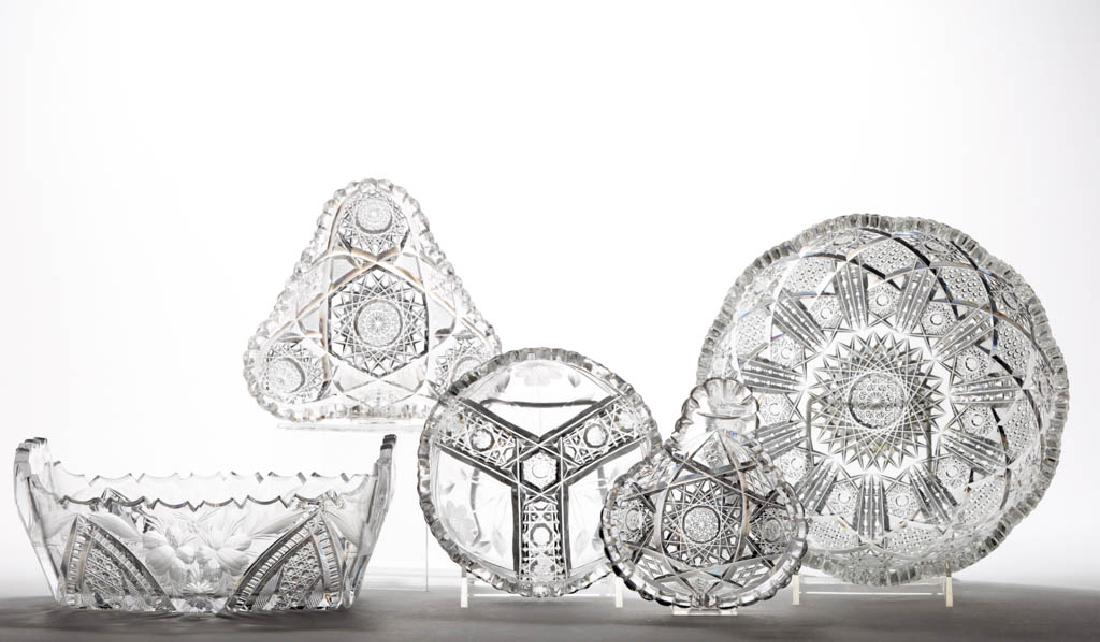 ASSORTED CUT GLASS ARTICLES, LOT OF FIVE: ASSORTED CUT GLASS ARTICLES, LOT OF FIVE, colorless, comprising a heavy serving bowl with detailed cuttings of hobstars, cane panels, and notched prisms, a rectangular bowl with cane and intaglio flor