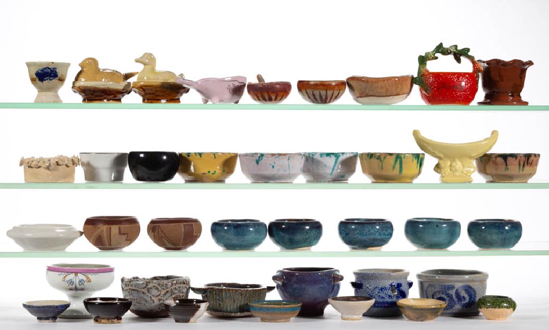 ASSORTED STONEWARE / EARTHENWARE OPEN SALTS, LOT OF 34: ASSORTED STONEWARE / EARTHENWARE OPEN SALTS, LOT OF 34, including four Native/Mesoamerican examples, one with wooden spoon, two bird on nest examples, five signed "Bob / Ridley" examples with variety 