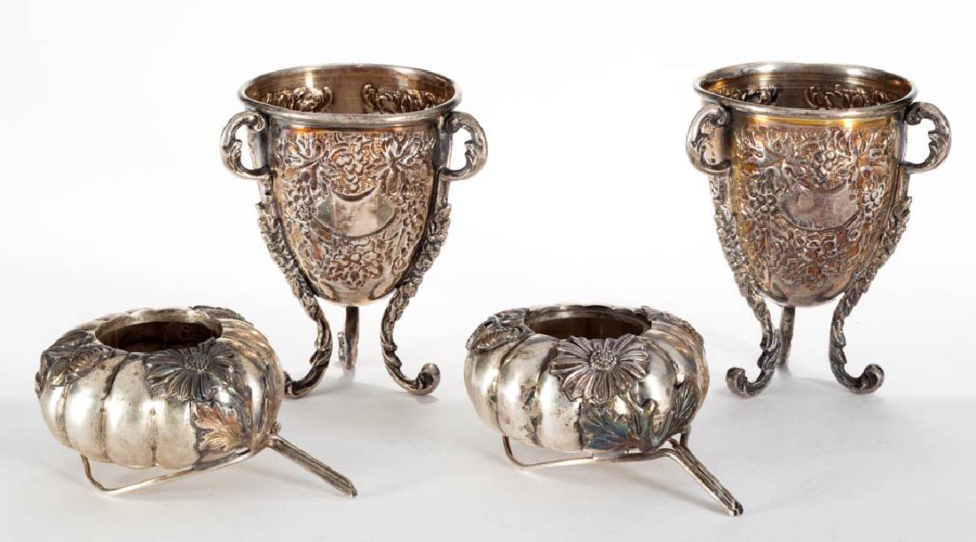 ASSORTED STERLING SILVER ARTICLES, LOT OF FOUR: ASSORTED STERLING SILVER ARTICLES, LOT OF FOUR, comprising a pair of pumpkin-shaped open salts with Aesthetic-style flower decoration having one glass interior liner, and a pair of egg cups with chase
