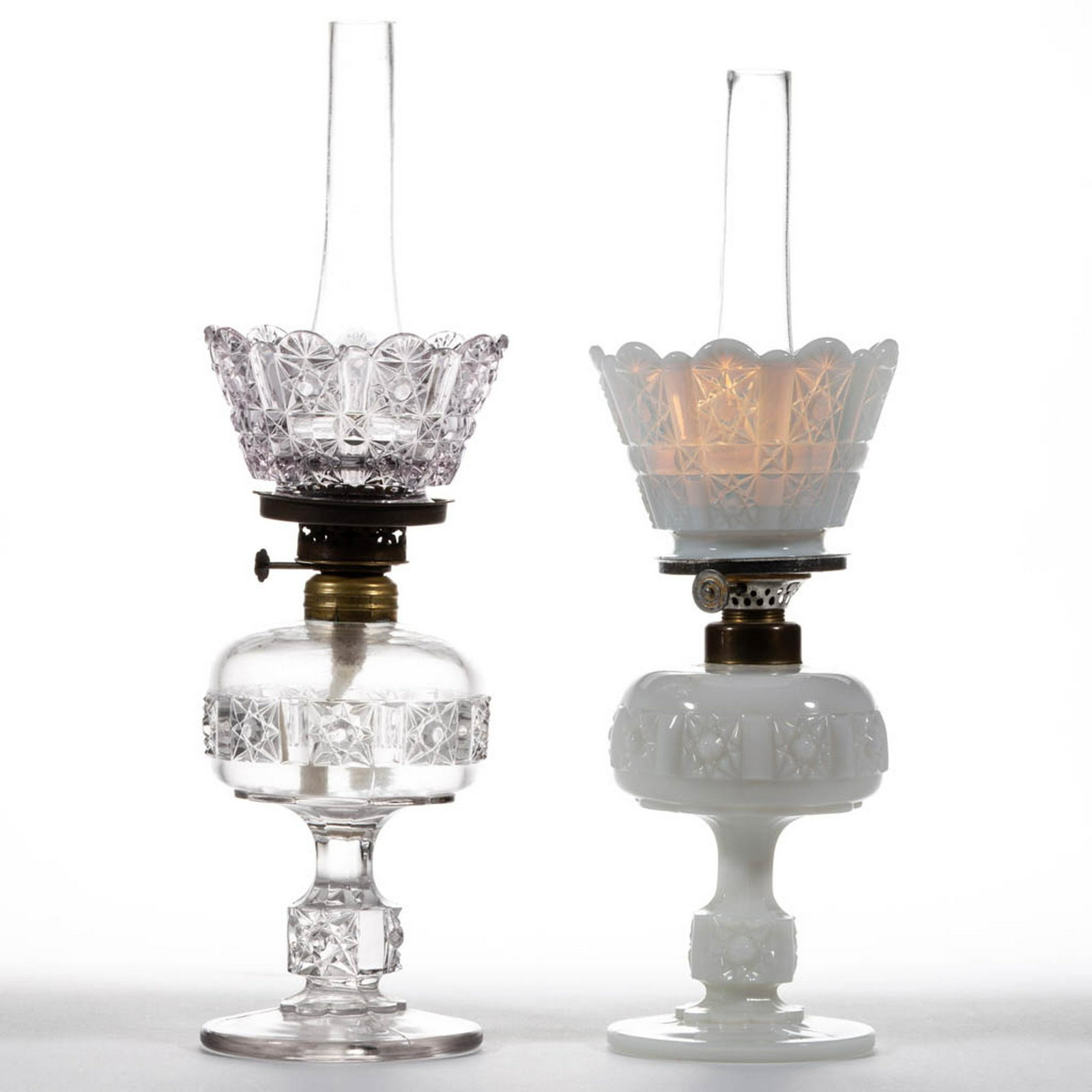DAISY AND CUBE / STARS AND BARS MINIATURE STAND LAMPS,: DAISY AND CUBE / STARS AND BARS MINIATURE STAND LAMPS, LOT OF TWO, colorless with a purple tint and opalescent, each having a compressed globular font on patterned standard, matching pattern crown-for