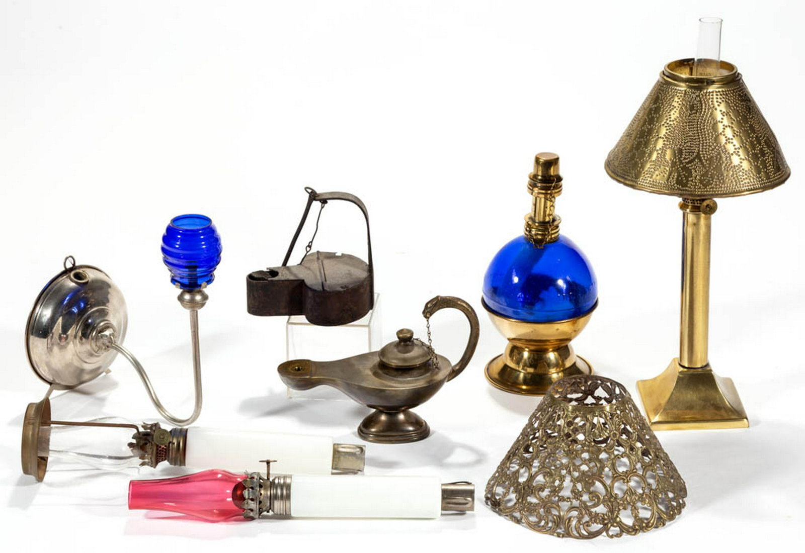 ASSORTED GLASS AND METAL LIGHTING DEVICES, LOT OF EIGHT: ASSORTED GLASS AND METAL LIGHTING DEVICES, LOT OF EIGHT, including a cobalt blue alcohol lamp with a single-tube burner, a "MONTREAL BEAUTY" miniature wall sconce, and two metal fluid lamps. Various m