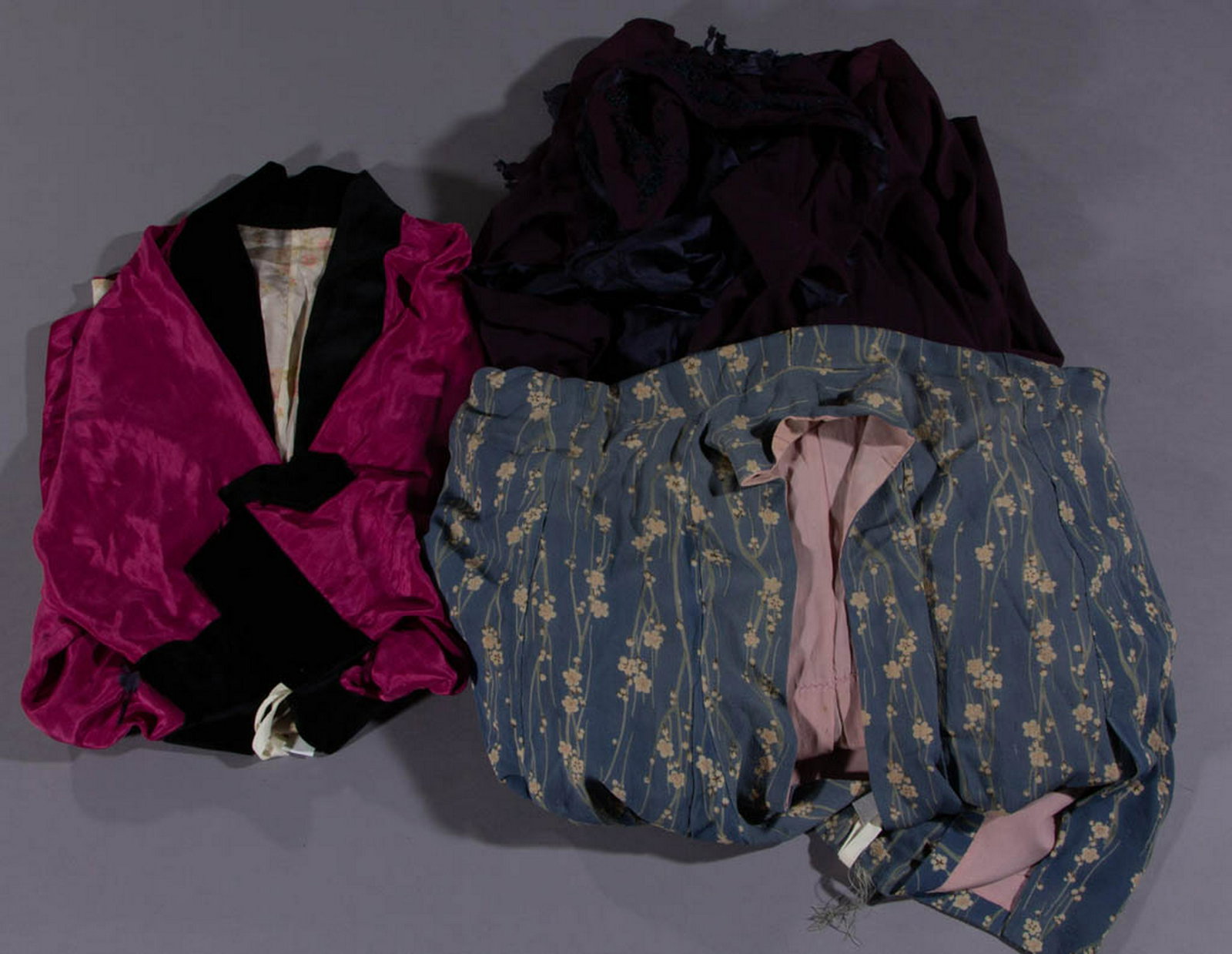 ANTIQUE / VINTAGE COATS AND CAPE, LOT OF THREE: ANTIQUE / VINTAGE COATS AND CAPE, LOT OF THREE, comprising a pink coat with black velvet trim and short sleeves, a kimono-type coat having floral print exterior fabric and a plain dusty pink interior 