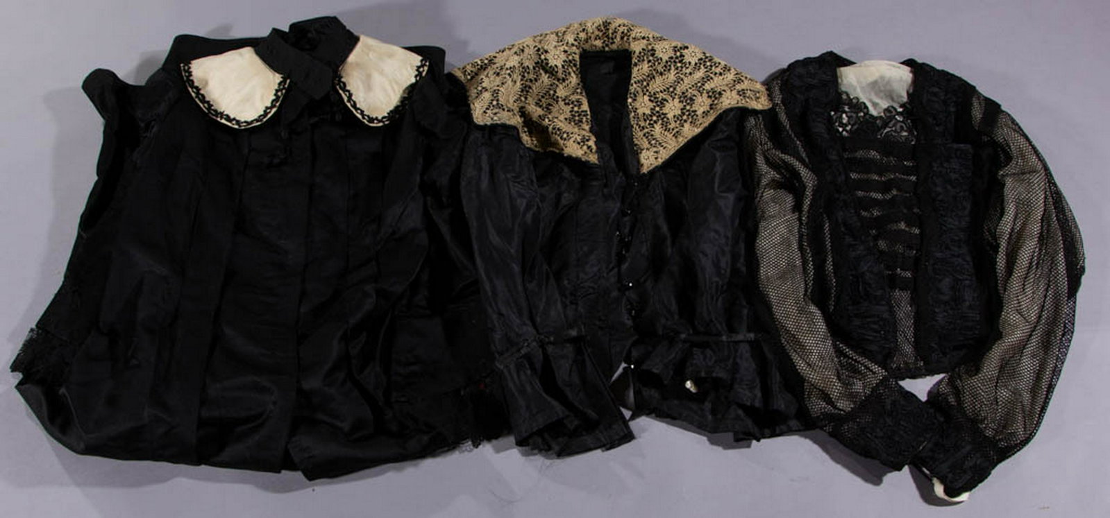 VICTORIAN / EDWARDIAN BLACK COAT AND BODICES, LOT OF: VICTORIAN / EDWARDIAN BLACK COAT AND BODICES, LOT OF THREE, comprising a satin coat with white collar, applied lace to end of sleeves, and a button closure front, a bodice having mesh exterior and cre