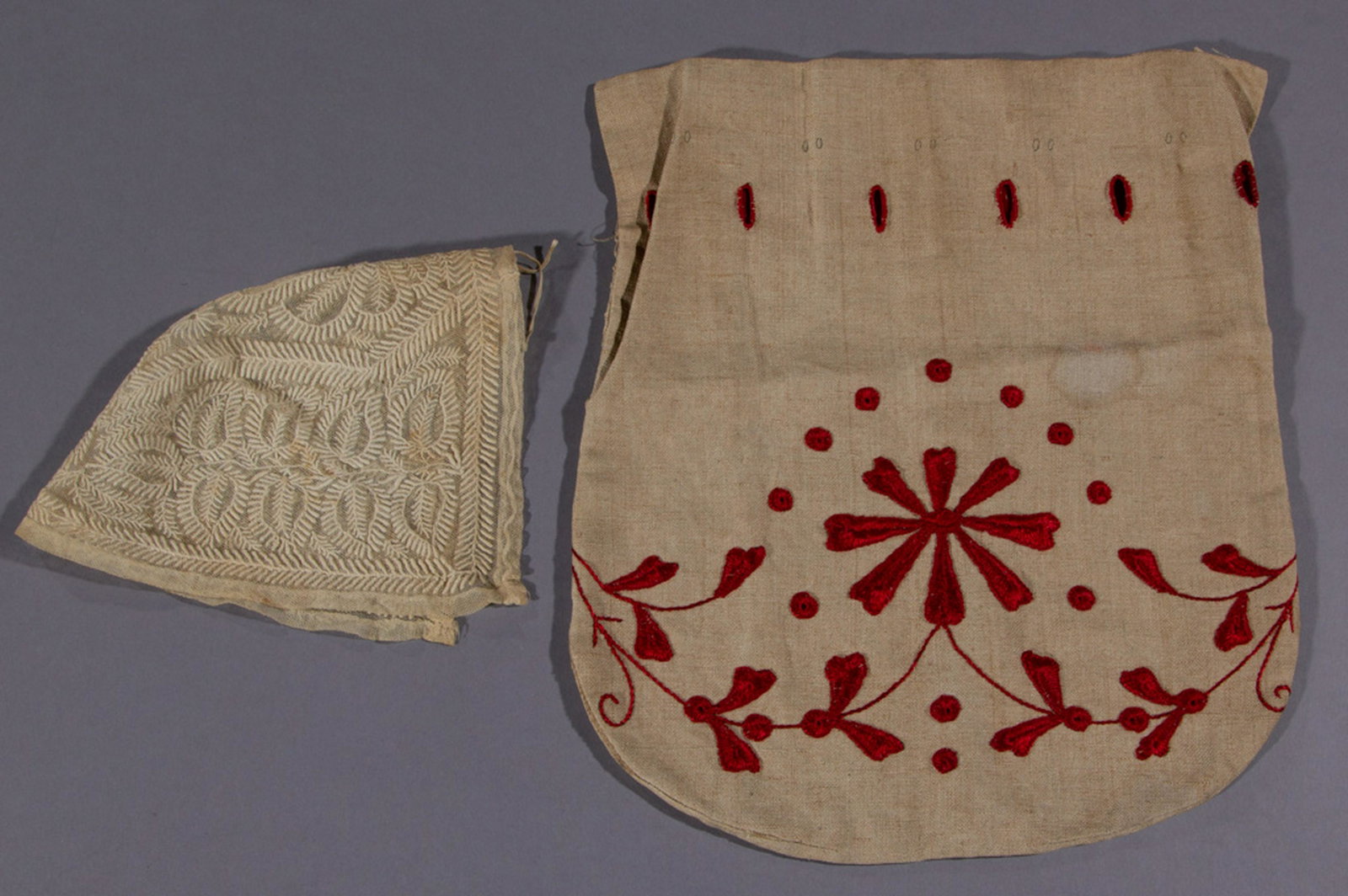 ANTIQUE NEEDLEWORK TEXTILE ARTICLES, LOT OF TWO: ANTIQUE NEEDLEWORK TEXTILE ARTICLES, LOT OF TWO, comprising a lace christening cap with embroidered foliate motifs and a single eyelet to top, and a linen purse with Turkey red embroidered designs. 19