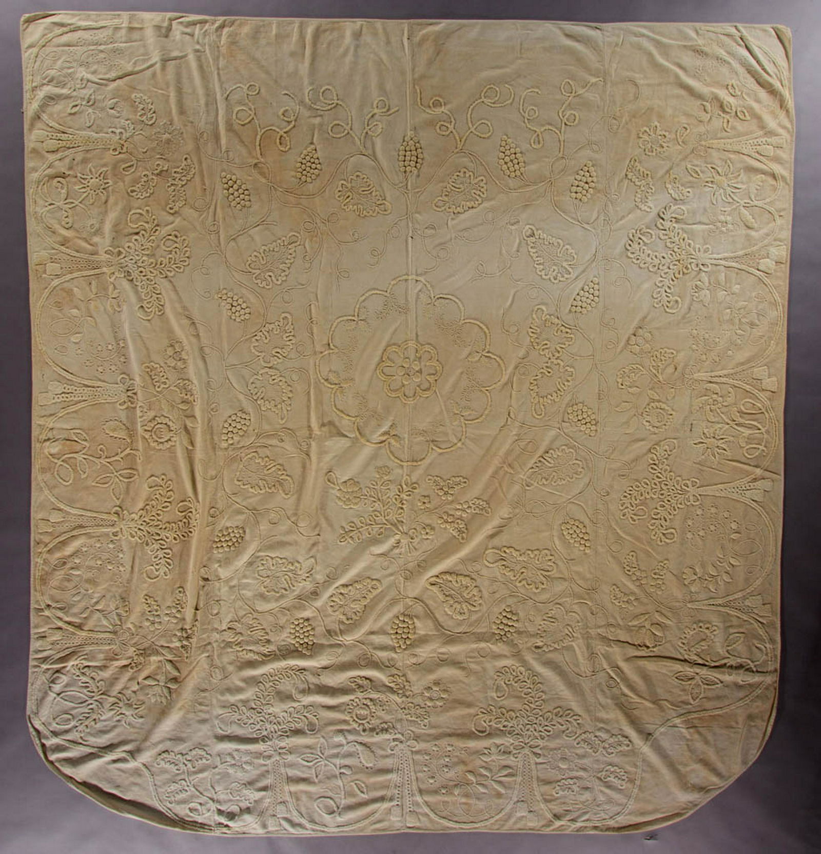 AMERICAN / ENGLISH COTTON CANDLEWICK EMBROIDERY: AMERICAN / ENGLISH COTTON CANDLEWICK EMBROIDERY COUNTERPANE, hand-stitched, four joined panels of diamond diaper-woven cloth featuring tufted and embroidered candlewick whitework, central floret with