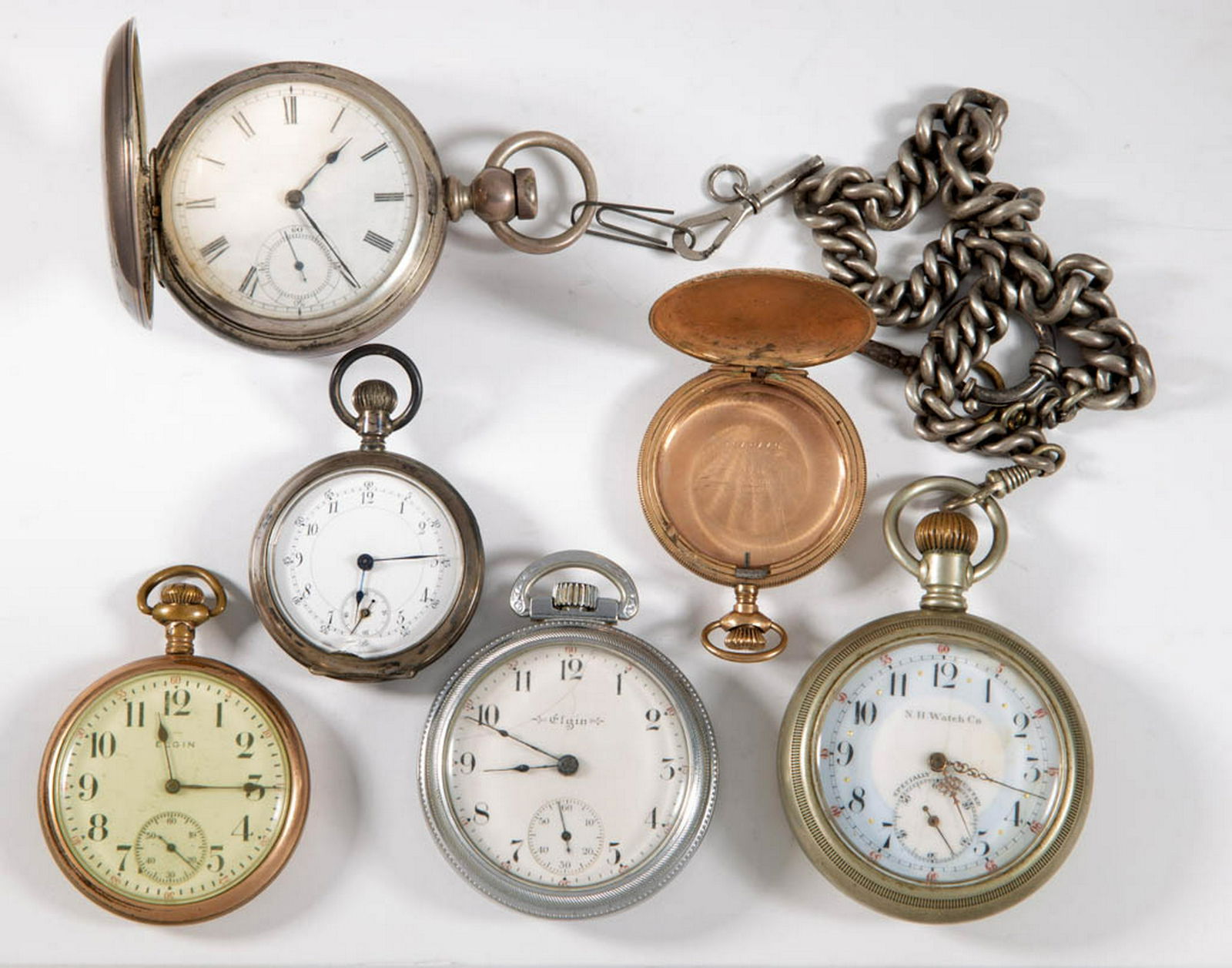 ASSORTED AMERICAN POCKET WATCHES, LOT OF FIVE: ASSORTED AMERICAN POCKET WATCHES, LOT OF FIVE, including a keywind Broadway Waltham in a coin silver hunter case with key; a keywind N. H. Watch Co open face with chain and key; and an Elgin dollar wa