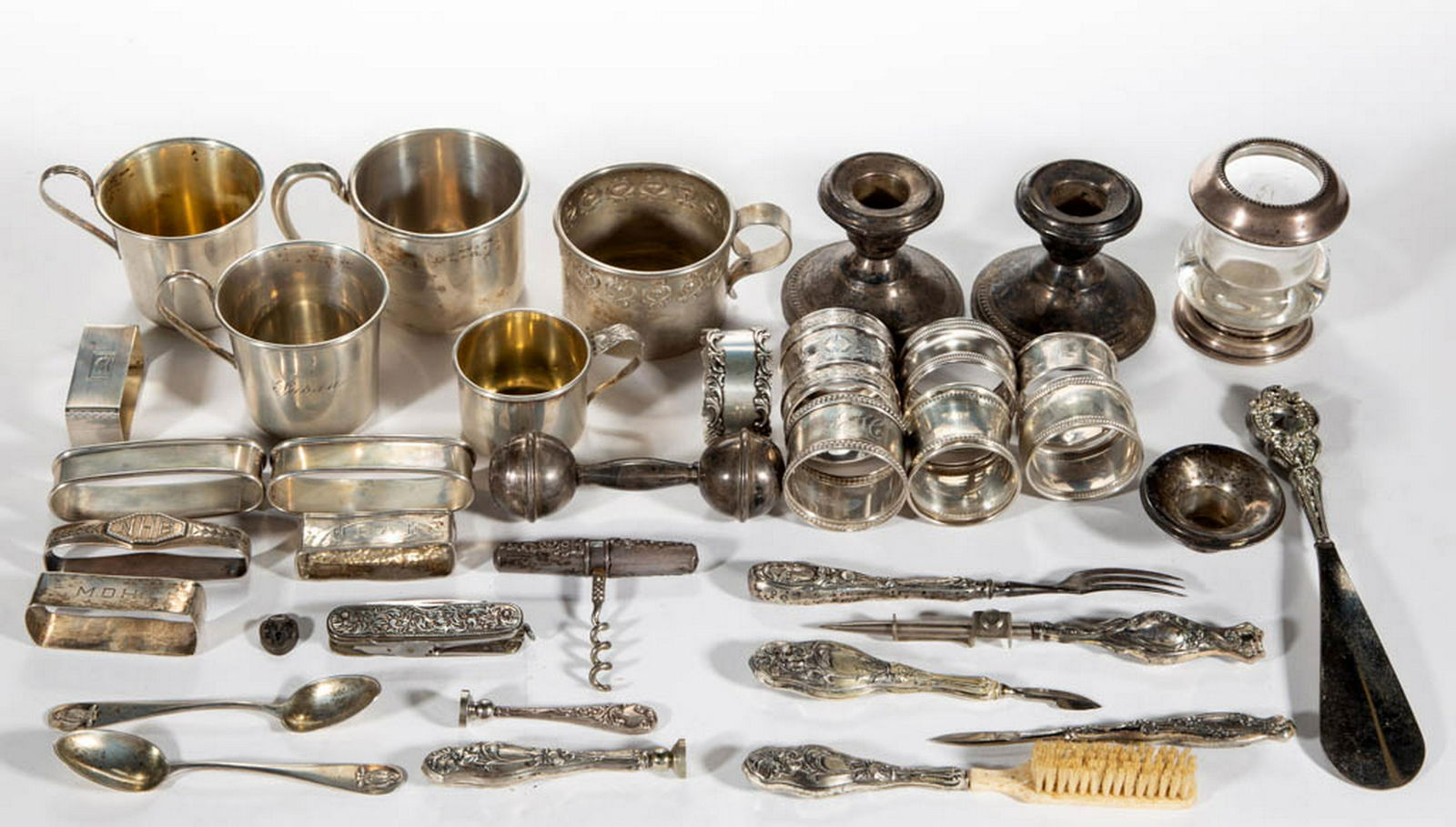 ASSORTED STERLING SILVER ARTICLES, LOT OF 36: ASSORTED STERLING SILVER ARTICLES, LOT OF 36, featuring several napkin rings, weighted candlesticks, and five baby cups, manufacturers include Gorham, Lunt Silversmiths, and International Silver Co. E