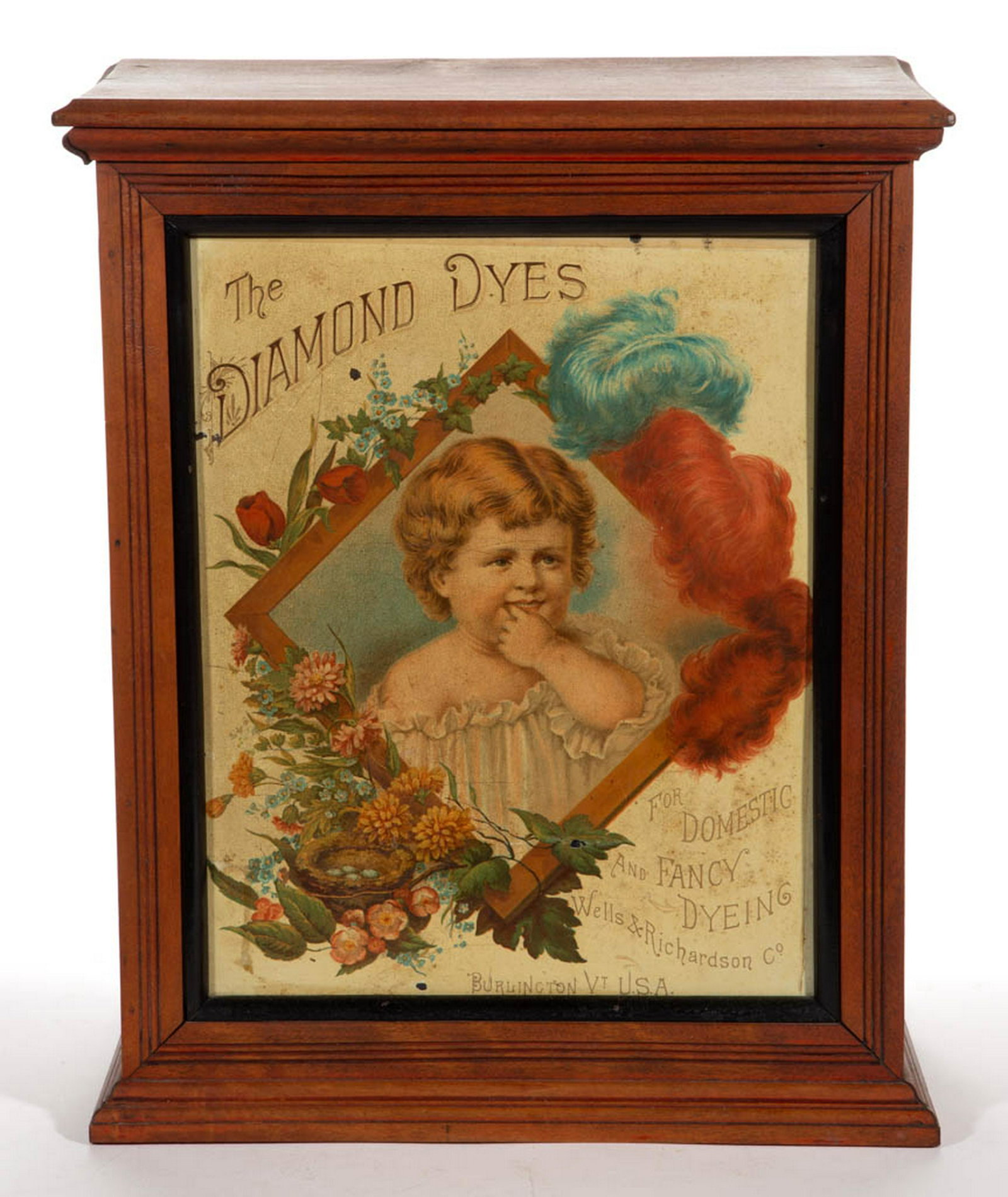DIAMOND DYES COUNTRY STORE DISPLAY CABINET: DIAMOND DYES COUNTRY STORE DISPLAY CABINET, birch case with lithographed tin panel insert in the "Baby" or "Presentation" pattern, fitted interior. Retains a worn red-washed surface. Fourth quarter 19