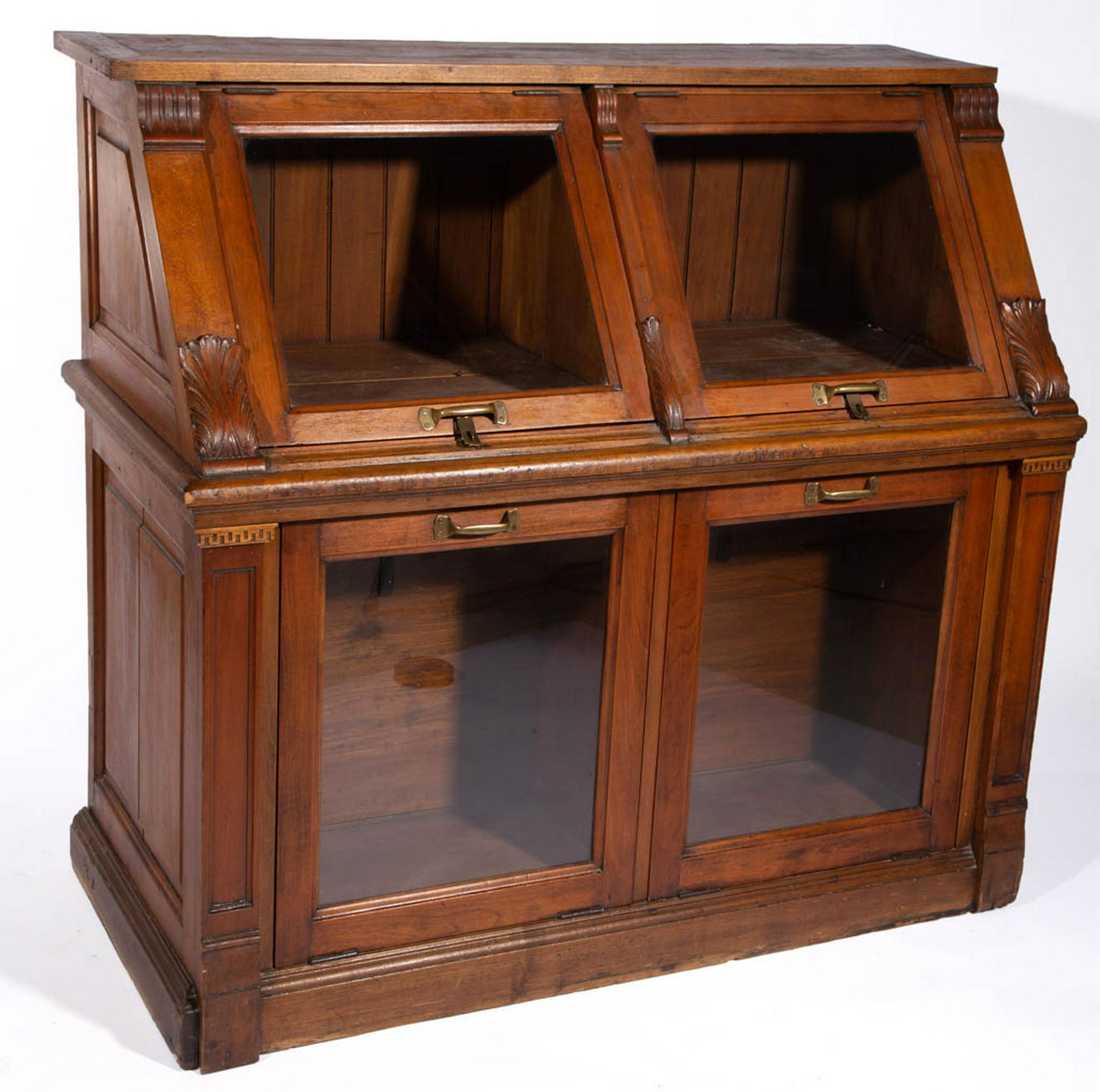 AMERICAN CARVED CHERRY COUNTRY STORE BIN: AMERICAN CARVED CHERRY COUNTRY STORE BIN, hinged slant-front form with dual bins below, ornamentation includes carved foliate devices. Old refinished surface. Late 19th/early 20th century. 43 1/2" H,