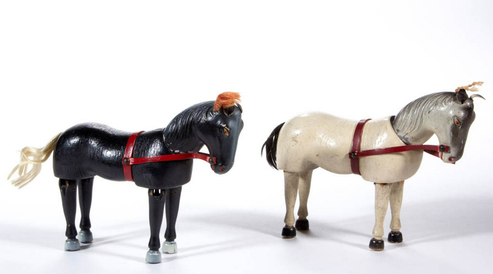 SCHOENHUT / HUMPTY DUMPTY CIRCUS TOY HORSES, LOT OF TWO: SCHOENHUT / HUMPTY DUMPTY CIRCUS TOY HORSES, LOT OF TWO, each jointed, comprising a black-and-white painted example stamped "HUMPTY DUMPTY TOYS" on the underside, and a Schoenhut example painted black
