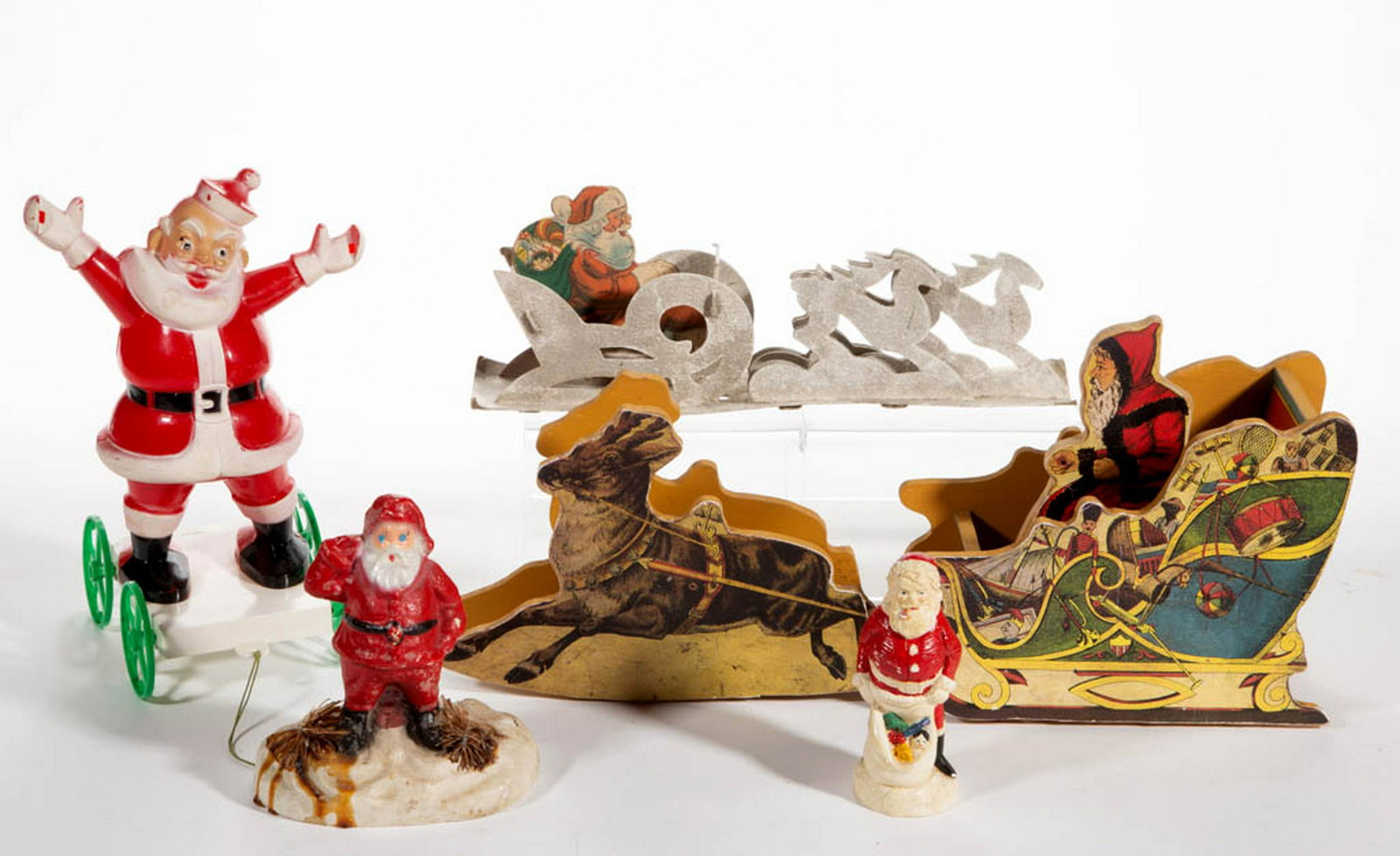 ASSORTED SANTA CLAUS FIGURES, LOT OF FIVE: ASSORTED SANTA CLAUS FIGURES, LOT OF FIVE, comprising a plastic pull toy by Rosbro Plastics of Provenance, RI, a papier-mache/composition container, a plaster/composition figure, a pasteboard sleigh a