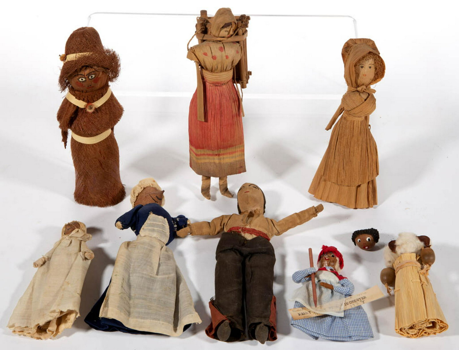 ASSORTED MATERIAL DOLLS, LOT OF EIGHT: ASSORTED MATERIAL DOLLS, LOT OF EIGHT, including two corn husk examples, one coconut husk example, three nut-head examples, and a cloth example having hand-stitched facial features with black and red 
