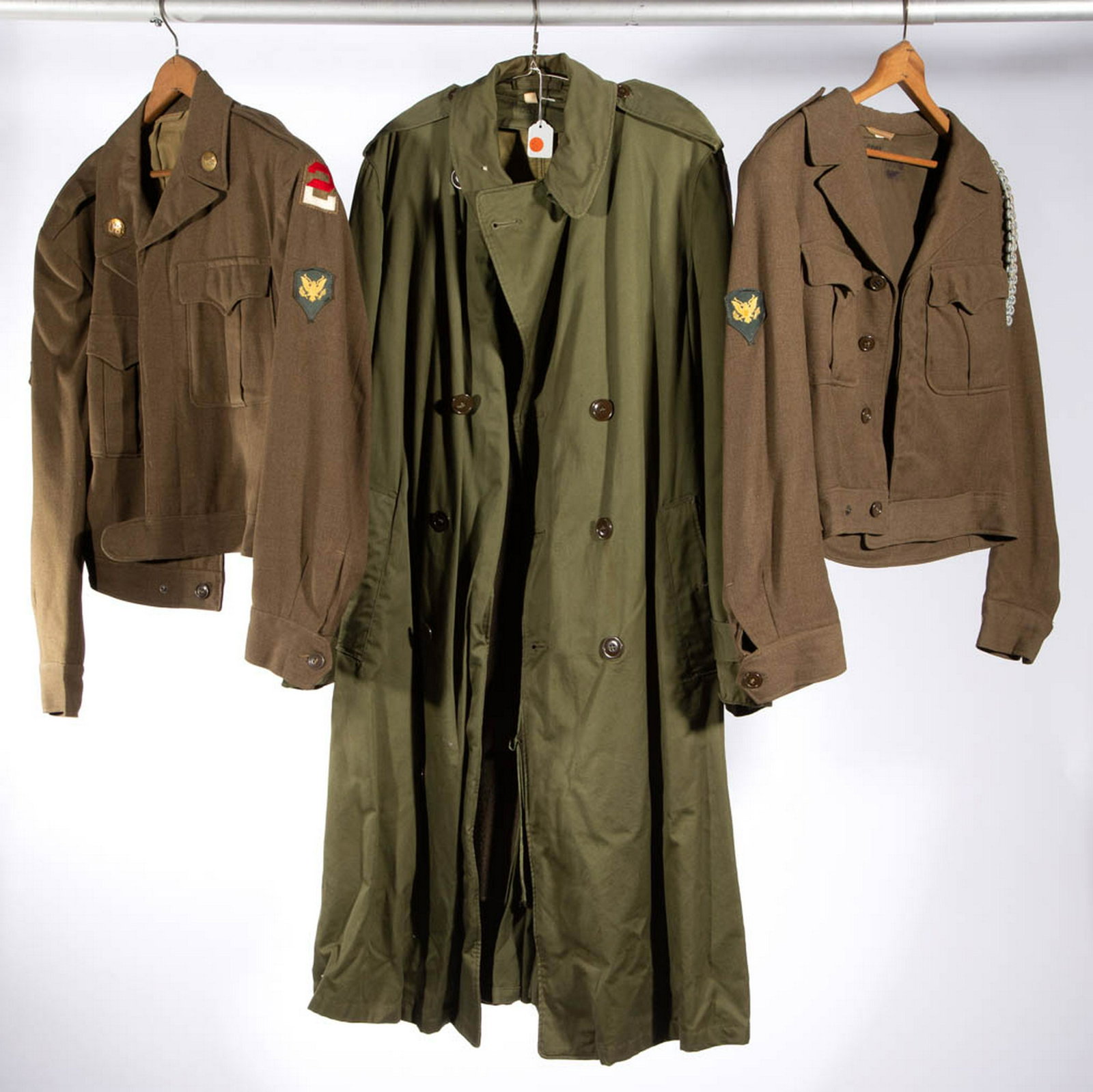 WORLD WAR TWO / KOREAN WAR ERA U.S. ARMY OVERCOAT /: WORLD WAR TWO / KOREAN WAR ERA U.S. ARMY OVERCOAT / JACKETS, LOT OF THREE, comprising an overcoat and dress uniform jacket with shoulder patch insignia for the 10th Mountain Division, and a dress unif
