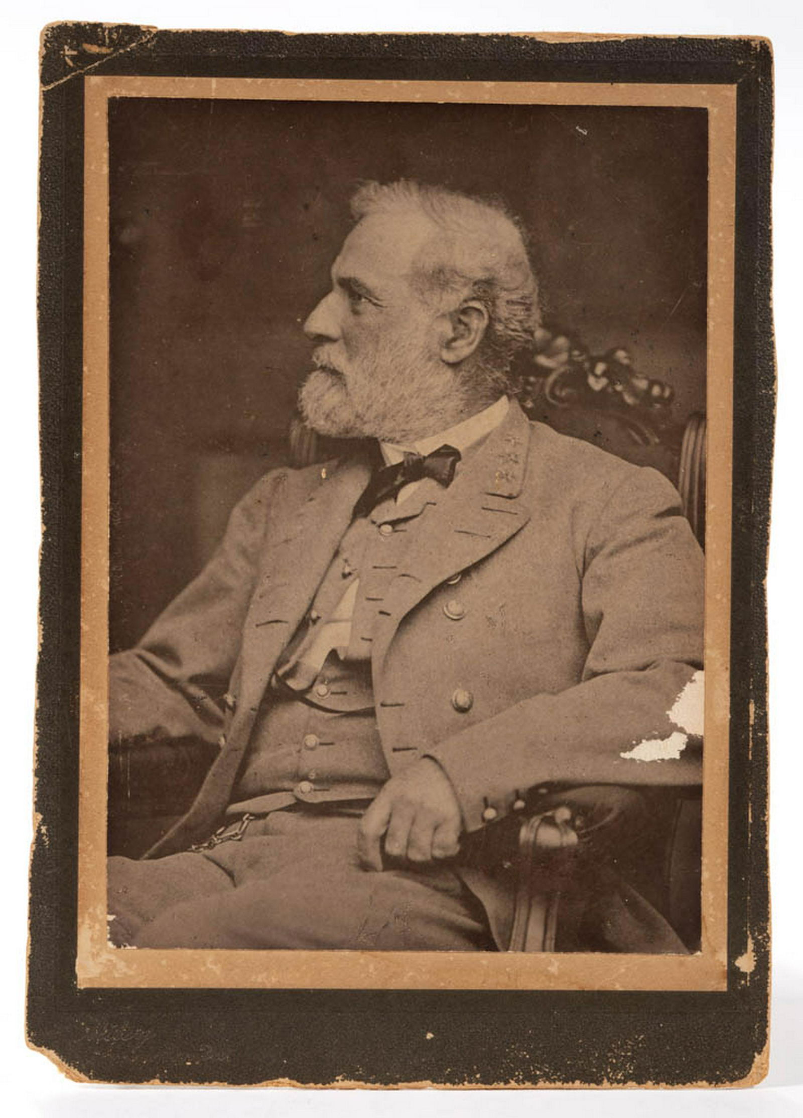 ROBERT E. LEE CABINET CARD PHOTOGRAPH: ROBERT E. LEE CABINET CARD PHOTOGRAPH, on board, post-war depiction of Lee wearing his uniform, vest partially unbuttoned, seated in an arm chair with carved crest, stamped "Miley / Lexington, Va" on