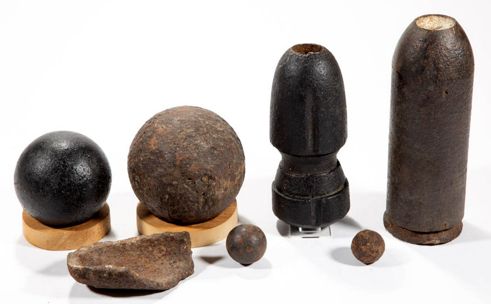 CIVIL WAR ERA ARTILLERY PROJECTILES, LOT OF FOUR: CIVIL WAR ERA ARTILLERY PROJECTILES, LOT OF FOUR, including a Hotchkiss shell and a Parrot shell. Together with two small balls and a piece of shrapnel. Seven pieces total. Circa 1863. Shells 7" and 8