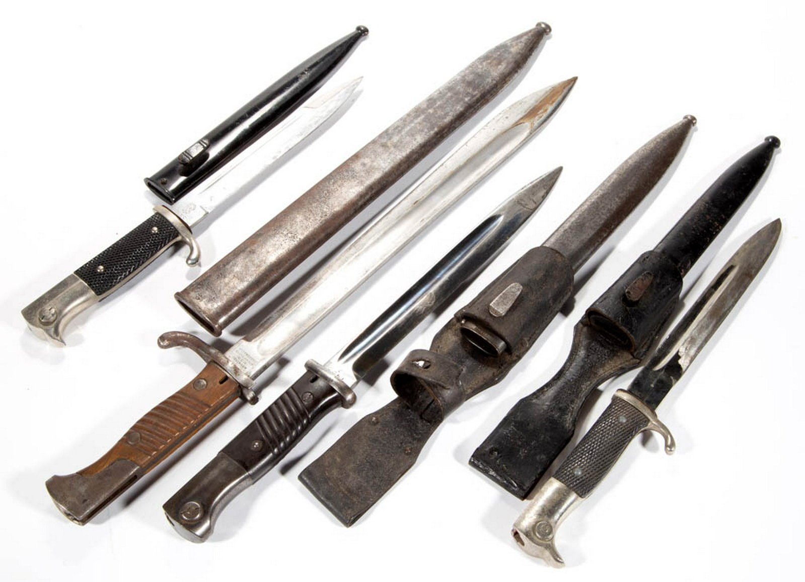 ASSORTED GERMAN MILITARY BAYONETS, LOT OF FOUR: ASSORTED GERMAN MILITARY BAYONETS, LOT OF FOUR, two with wooden grips and two with checkered plastic grips, two marked "WKC", one marked "WEYERSBERG / KIRSCHBAUM / & Cie / SOLINGEN", last unmarked, ea