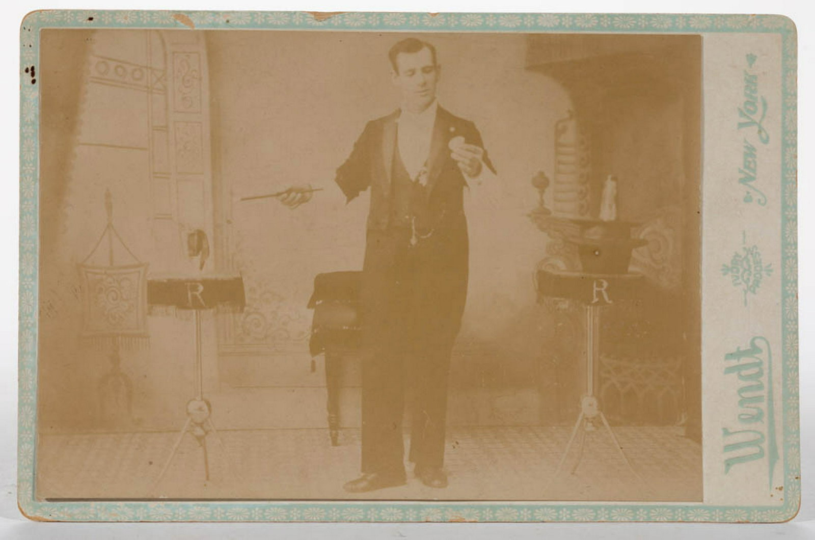 AMERICAN MAGICIAN CABINET CARD: AMERICAN MAGICIAN CABINET CARD, albumen print on cardstock, marked for photographer Wendt, New York, and featuring a gentleman with wand, top hat resting on table in the background. Circa 1890. 4" x 6