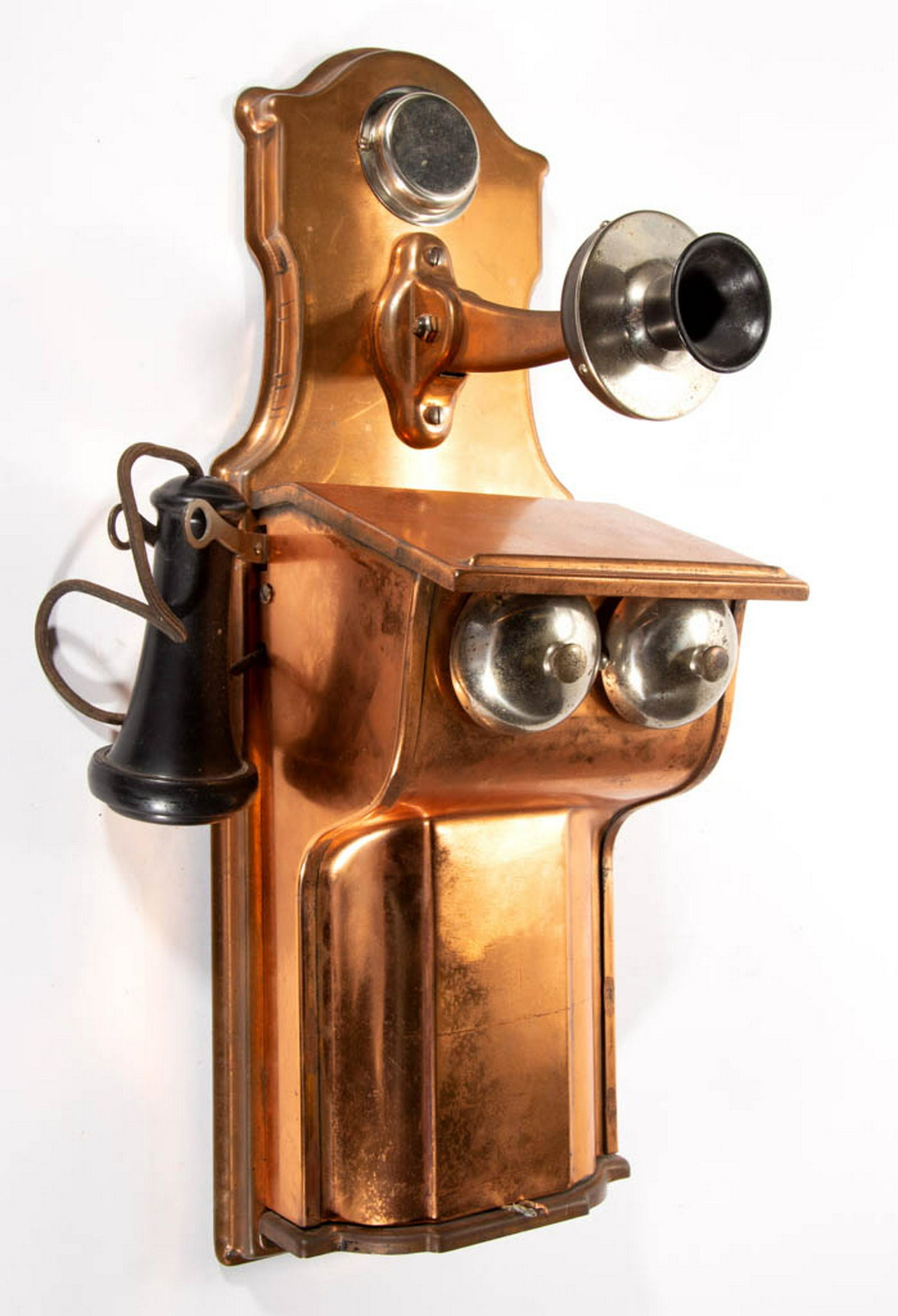 ANTIQUE COPPER WALL TELEPHONE: ANTIQUE COPPER WALL TELEPHONE, fiddle-back, with copper mounted mouth piece, central two-bell box with receiver, and hand crank, no markings. First quarter 20th century. 21" H, 7" W. Very good overall