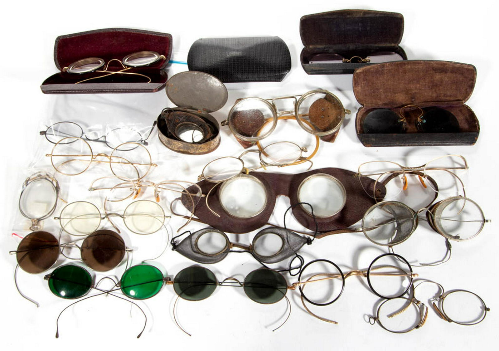ASSORTED ANTIQUE / VINTAGE EYE GLASSES / SPECTACLES,: ASSORTED ANTIQUE / VINTAGE EYE GLASSES / SPECTACLES, LOT OF 21, including five in possibly original cases, and safety glasses examples. 19th/first half 20th century. Various sizes.Fair to very good ov