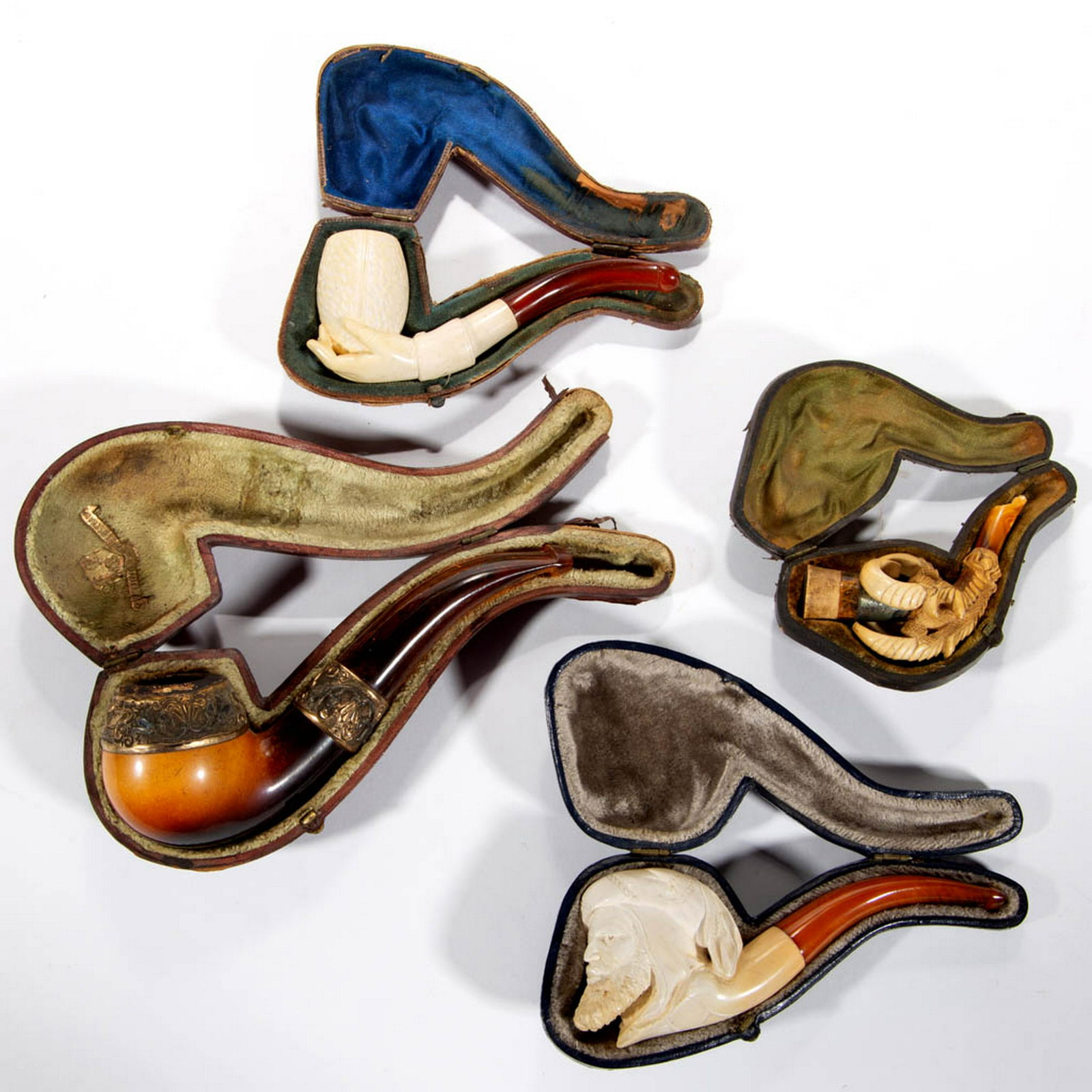 MEERSCHAUM CARVED FIGURAL PIPES WITH CASES, LOT OF: MEERSCHAUM CARVED FIGURAL PIPES WITH CASES, LOT OF THREE, comprising a curved raptor talon, hand holding the pipe bowl, and an Arabian man. Together with a Meerschaum pipe having chased gold-plate dec