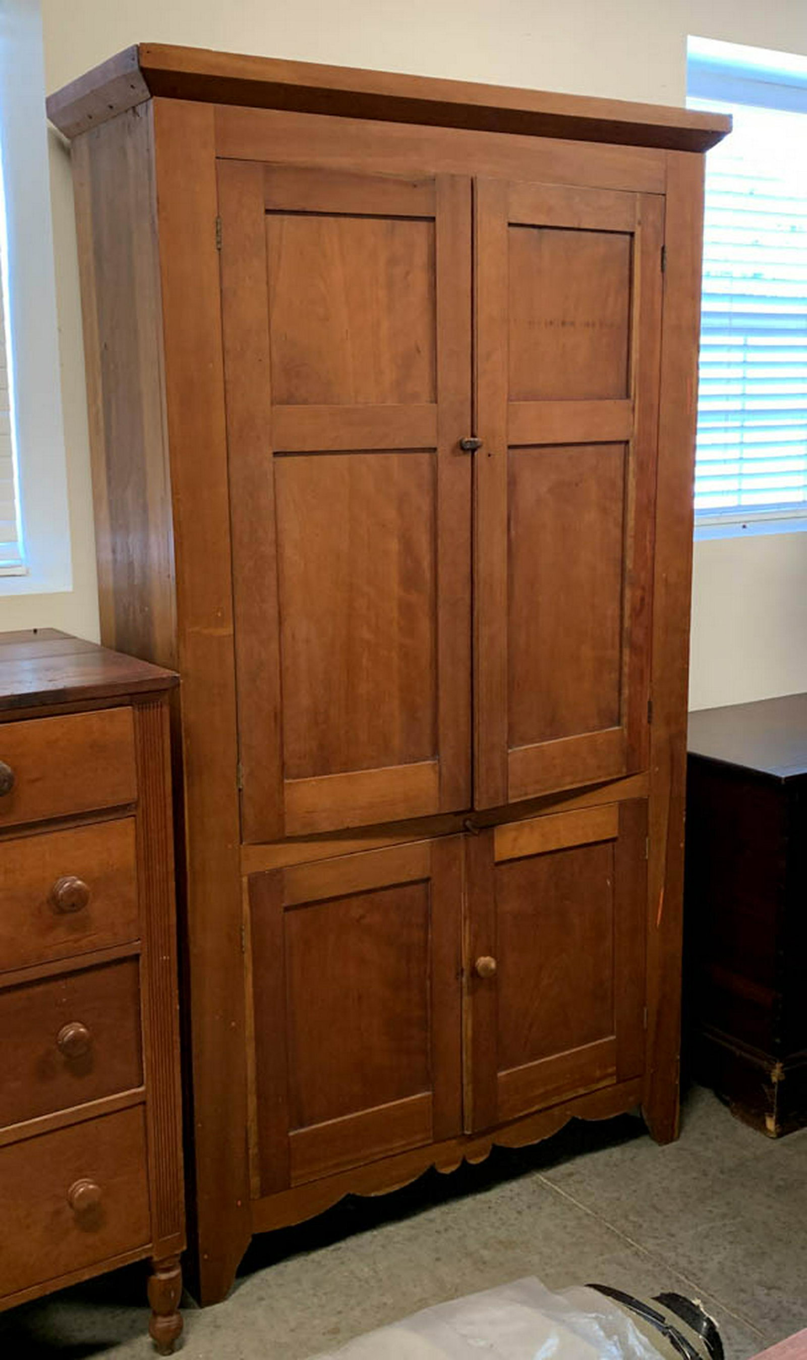 AMERICAN COUNTRY CHERRY FLATWALL CUPBOARD: AMERICAN COUNTRY CHERRY FLATWALL CUPBOARD, applied cornice, fielded-panel doors, cut-out skirt, solid ends. Old refinished surface. Mid 19th century. 84" H, 47" W, 15 1/2" D. Good overall condition wi