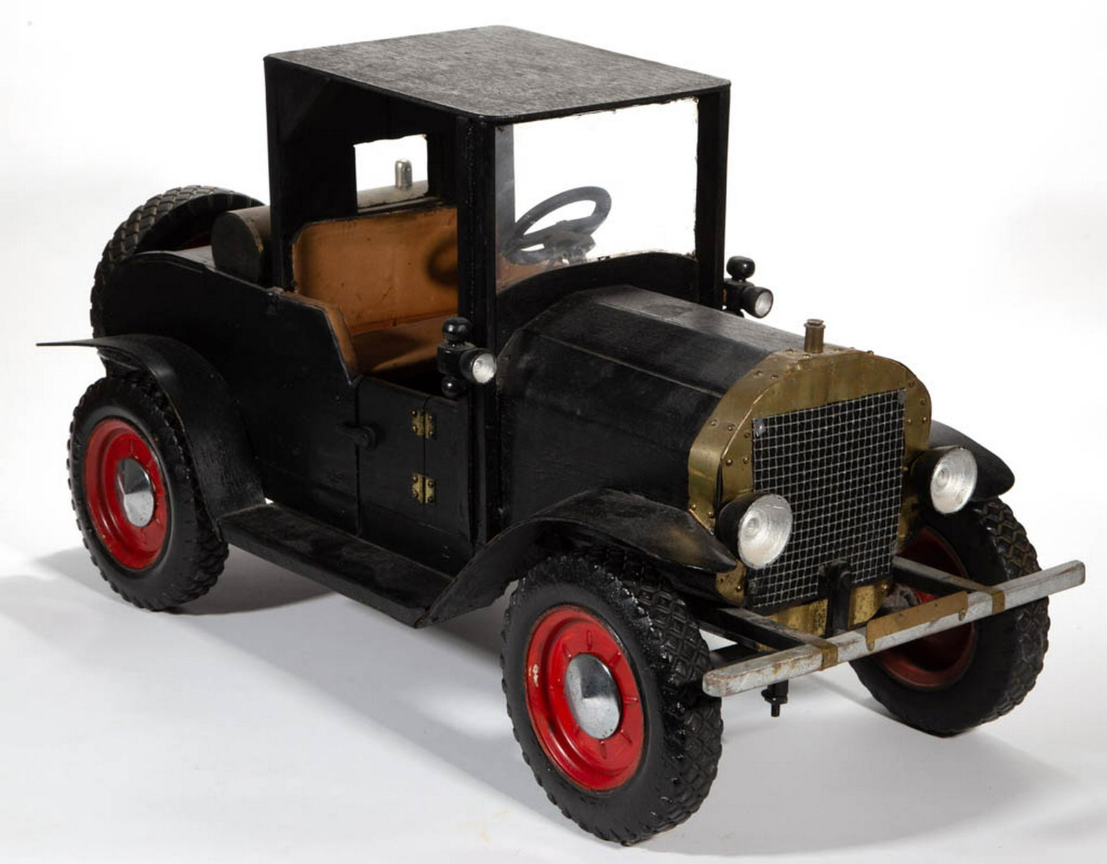 FOLK ART PAINTED CAR MODEL: FOLK ART PAINTED CAR MODEL, depicting an early vehicle with, headlamps, rubber tires, and upholstered seat cushions, retaining original painted surface. Mid 20th century. 17 1/2" H, 14" W, 17 1/2" L. 