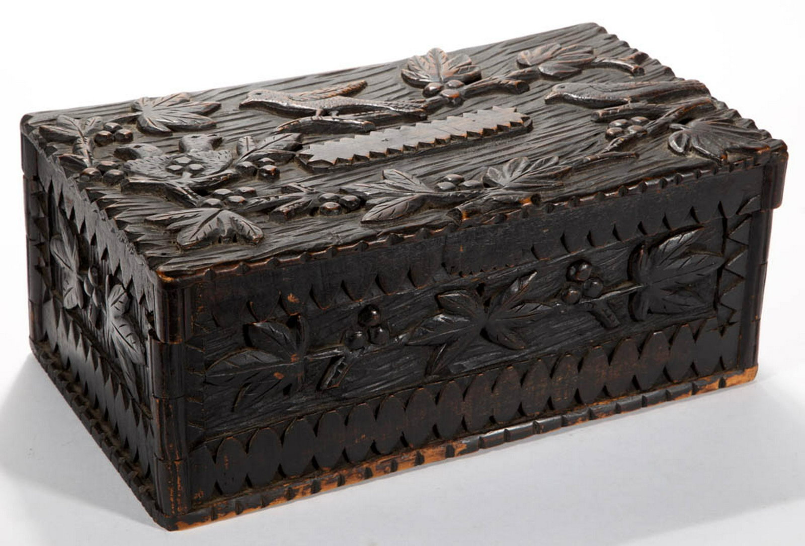 FOLK ART CARVED WORK BOX: FOLK ART CARVED WORK BOX, hinged top, with two birds guarding a nest on the top lid, and leaf and other geometric designs around the box. Retains an old stained / varnished surface with warm color. La