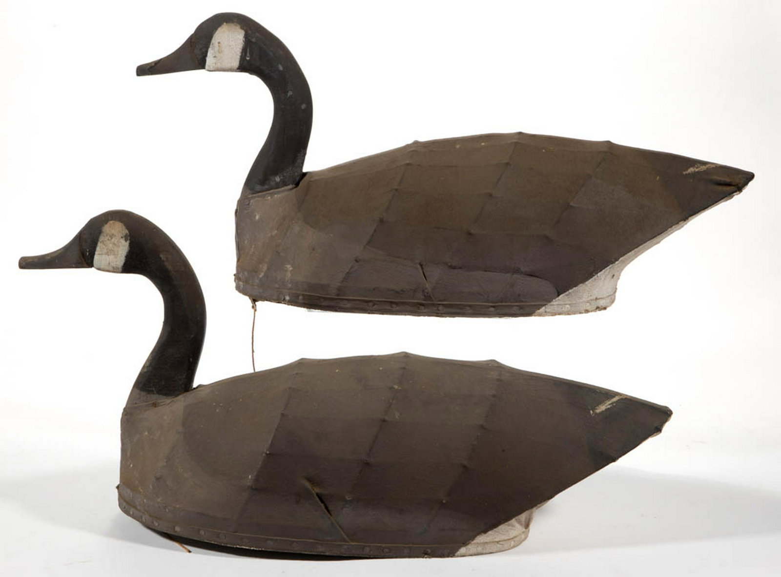 FOLK ART CARVED AND PAINTED PAIR OF CANADIAN GOOSE: FOLK ART CARVED AND PAINTED PAIR OF CANADIAN GOOSE DECOYS, each having canvas body stretched over supports. Surfaces with possibly original paint. 20th century. One 27 1/4" L, 13 1/4" H. Good overall 