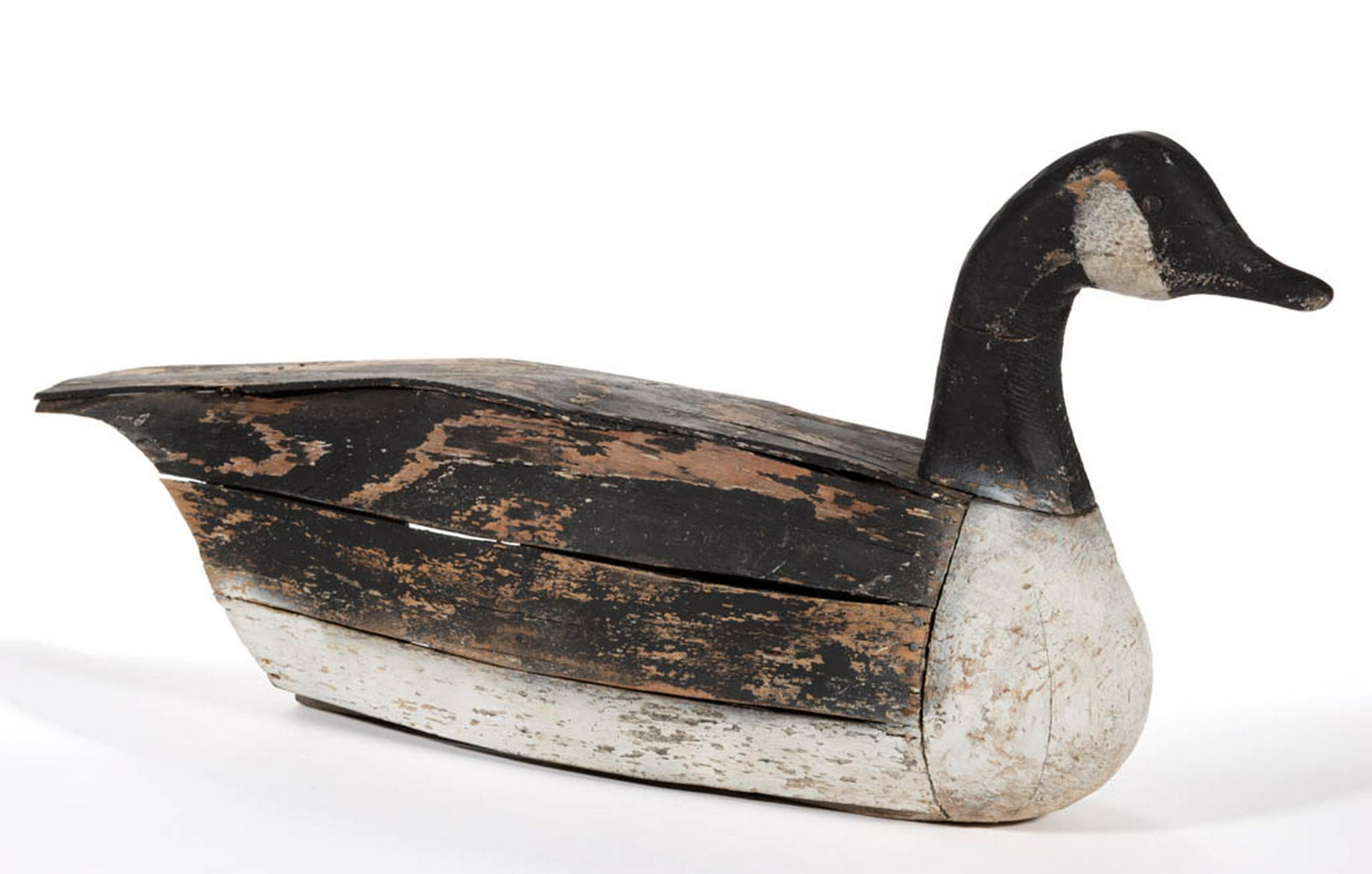 FOLK ART CARVED AND PAINTED CANADIAN GOOSE DECOY: FOLK ART CARVED AND PAINTED CANADIAN GOOSE DECOY, hollow-body form. Surface with likely original paint having some inpainting. 20th century. 32 1/4" L, 14 7/8" H. Fair overall condition with wear, som