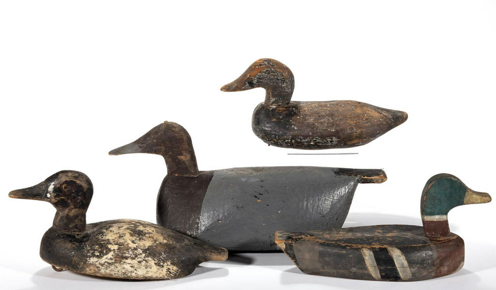 FOLK ART CARVED AND PAINTED DUCK DECOYS, LOT OF FOUR: FOLK ART CARVED AND PAINTED DUCK DECOYS, LOT OF FOUR, each with solid-body form, two with weights comprising largest example with painted "G" to base and a canvasback drake with "T&G" and "M" marks to