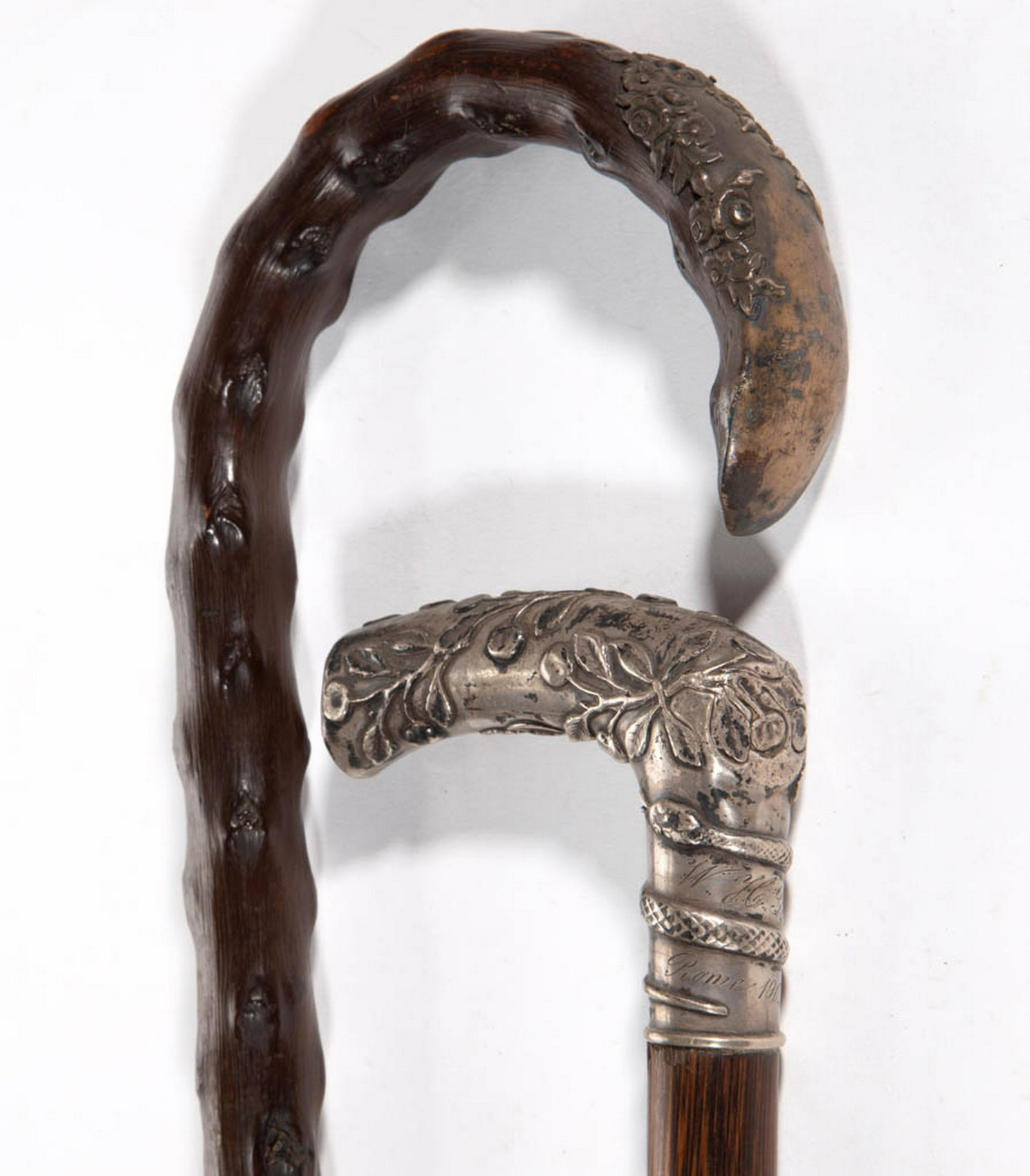 GERMAN .800 SILVER-HANDLED AND OTHER CANES / WALKING: GERMAN .800 SILVER-HANDLED AND OTHER CANES / WALKING STICKS, LOT OF TWO, comprising one example with a silver-toned cap featuring roses to end of handle, and one with entwining serpent, impressed Germ