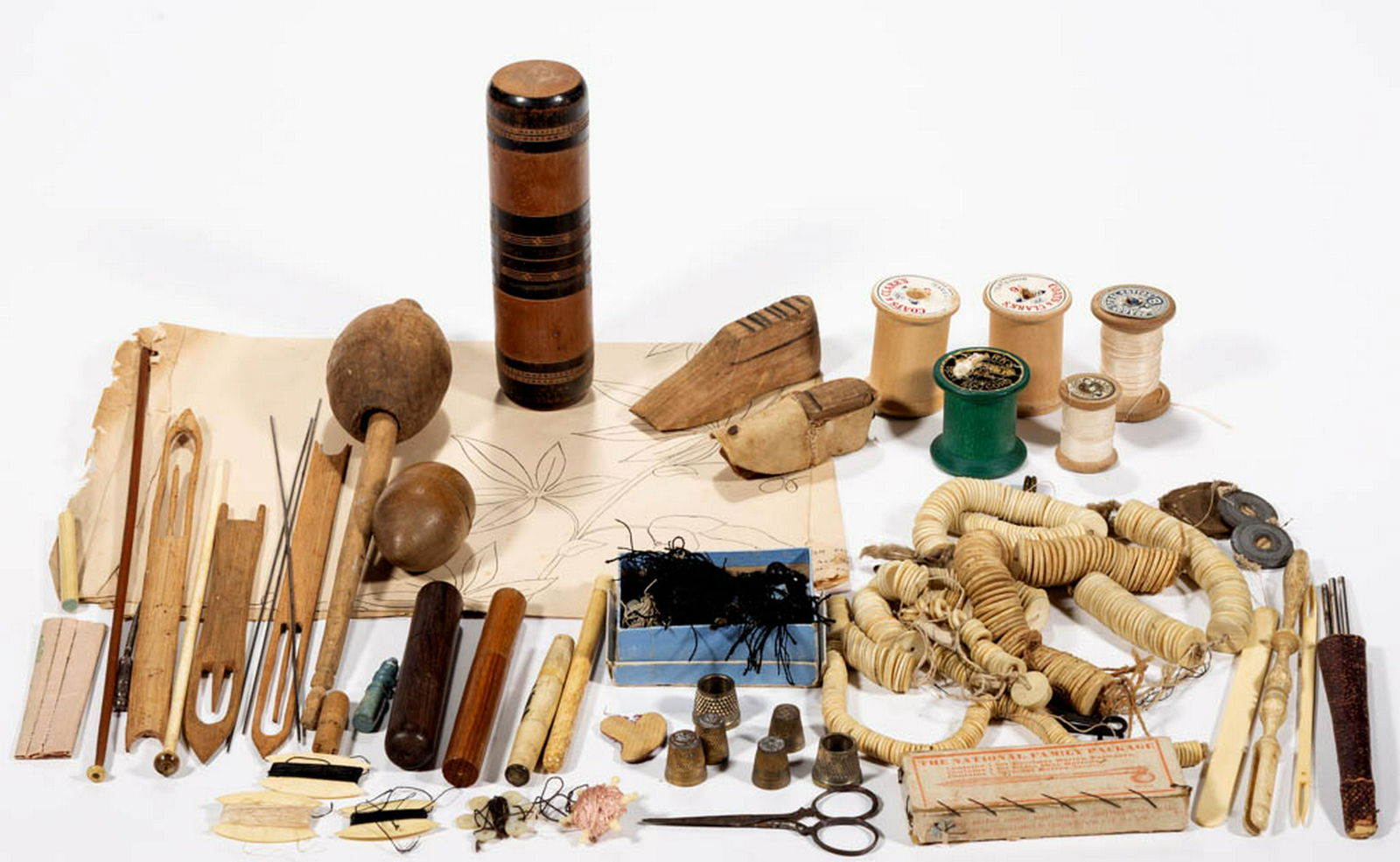 ANTIQUE SEWING ARTICLES, UNCOUNTED LOT: ANTIQUE SEWING ARTICLES, UNCOUNTED LOT, more than 100 pieces, including a strand of bone buttons, three wooden needle cases, bone and shell thread winders, a printed embroidery design from the Royal S
