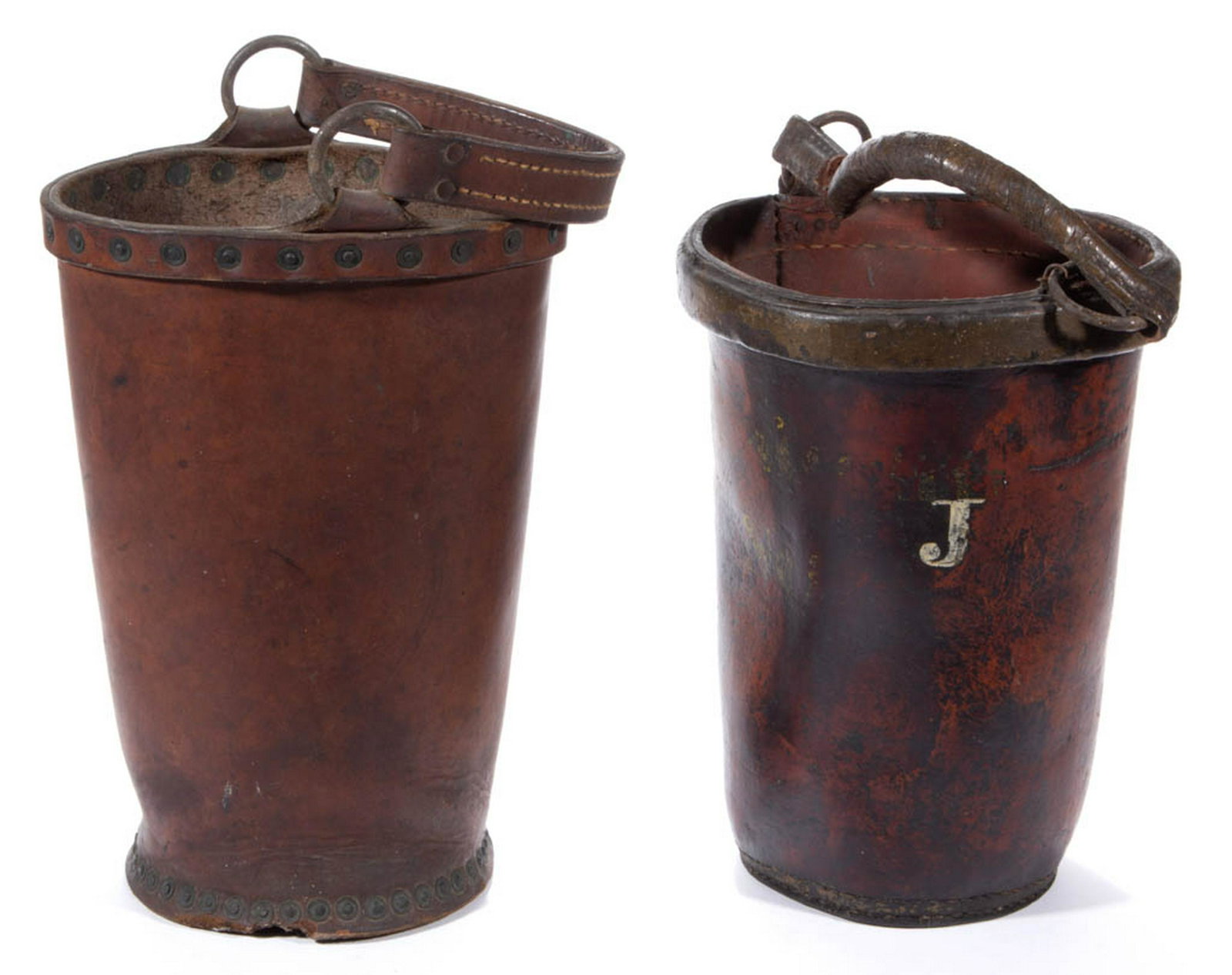 AMERICAN LEATHER FIRE BUCKET: AMERICAN LEATHER FIRE BUCKET, with a white-painted "J" and a wing bail handle. Together with a possible leather feed bucket with swing bail handle. Two pieces total. 19th century. 12" H rim. Good cond