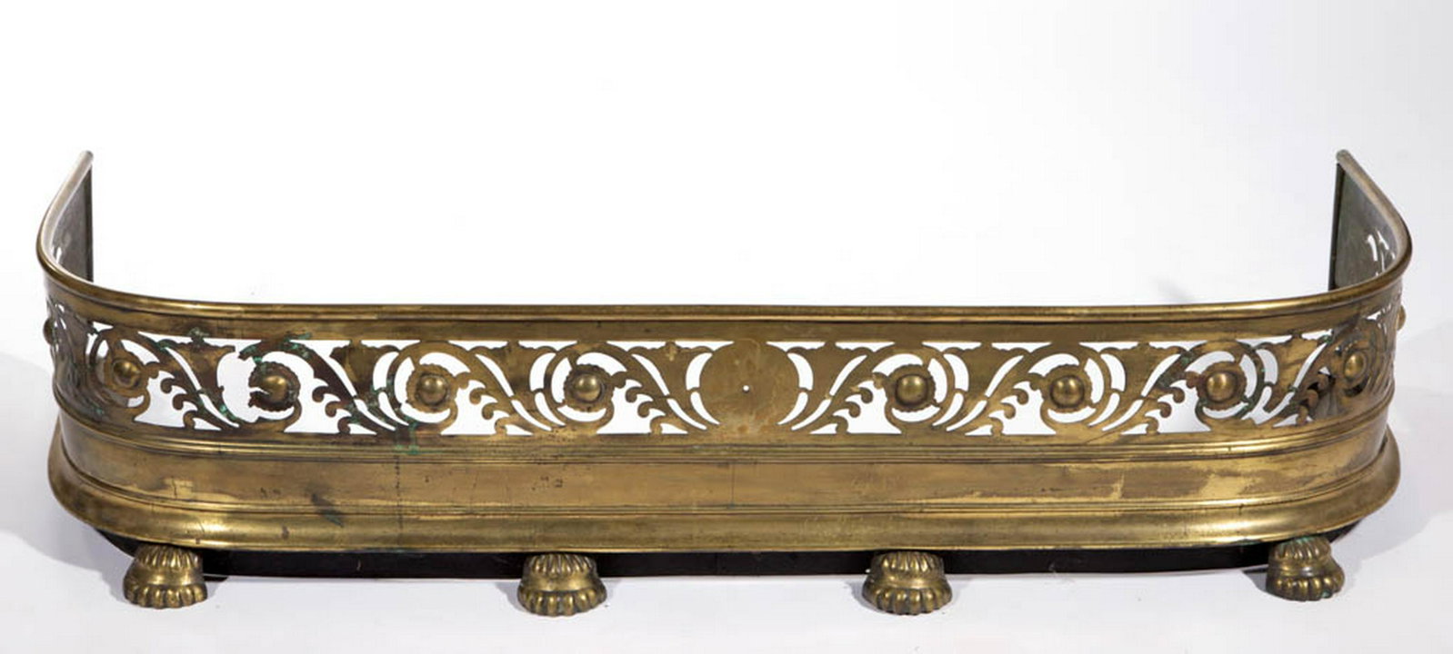 AMERICAN OR ENGLISH BRASS FIREPLACE FENDER: AMERICAN OR ENGLISH BRASS FIREPLACE FENDER, D-shape with four applied feet. First quarter 19th century. 4" H, 45 3/4" W, 16 1/4" D. Very good overall condition, minor areas of discoloration, with area