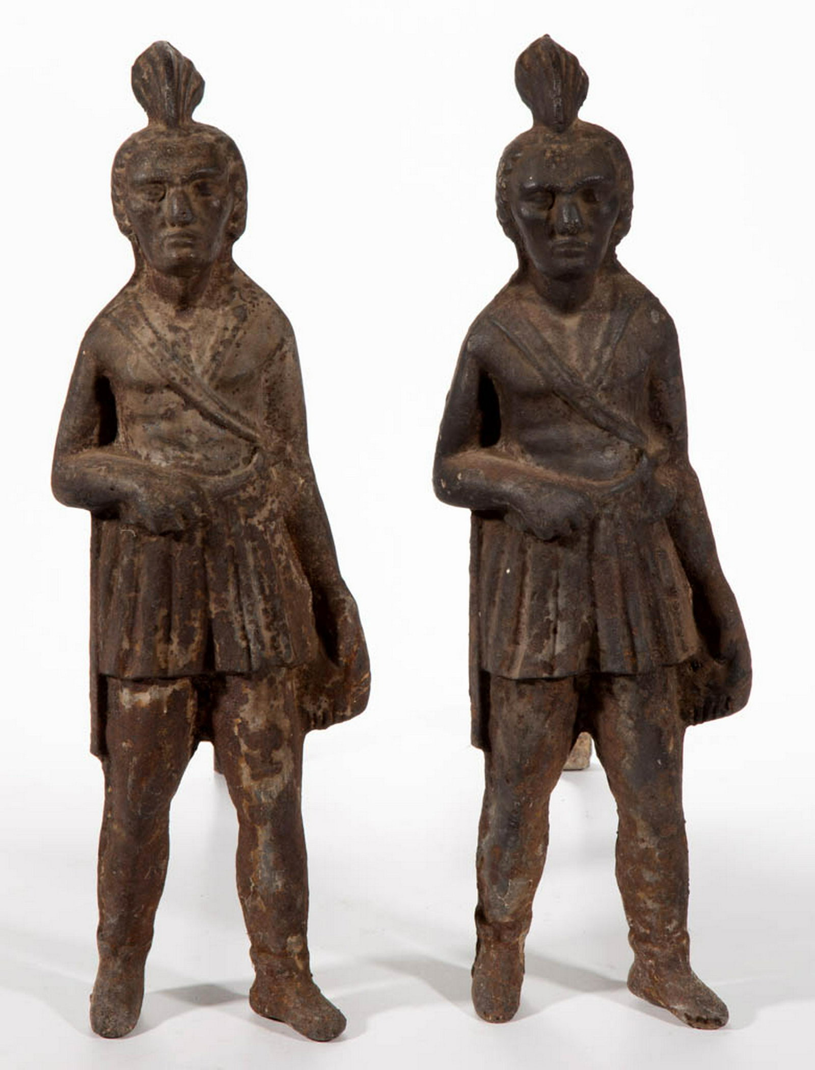 PAIR OF INDIAN FIGURAL CAST-IRON ANDIRONS: PAIR OF INDIAN FIGURAL CAST-IRON ANDIRONS, possibly depicting Chief Massasoit, one Indian with an embossed "S" on the back of his head. Late 19th/early 20th century. 20" H, 17 1/4" D. One with losses 