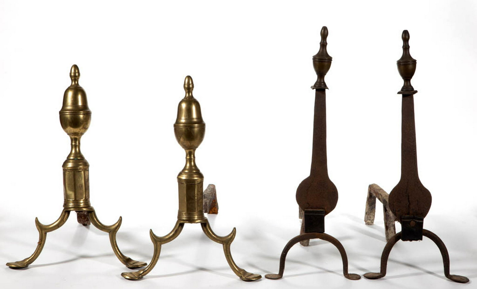 AMERICAN BRASS AND IRON PAIR OF ANDIRONS: AMERICAN BRASS AND IRON PAIR OF ANDIRONS, each shaped knife-blade shaft with brass urn-form finial, raised on arched legs terminating in penny feet, original log supports. Together with a pair of Amer