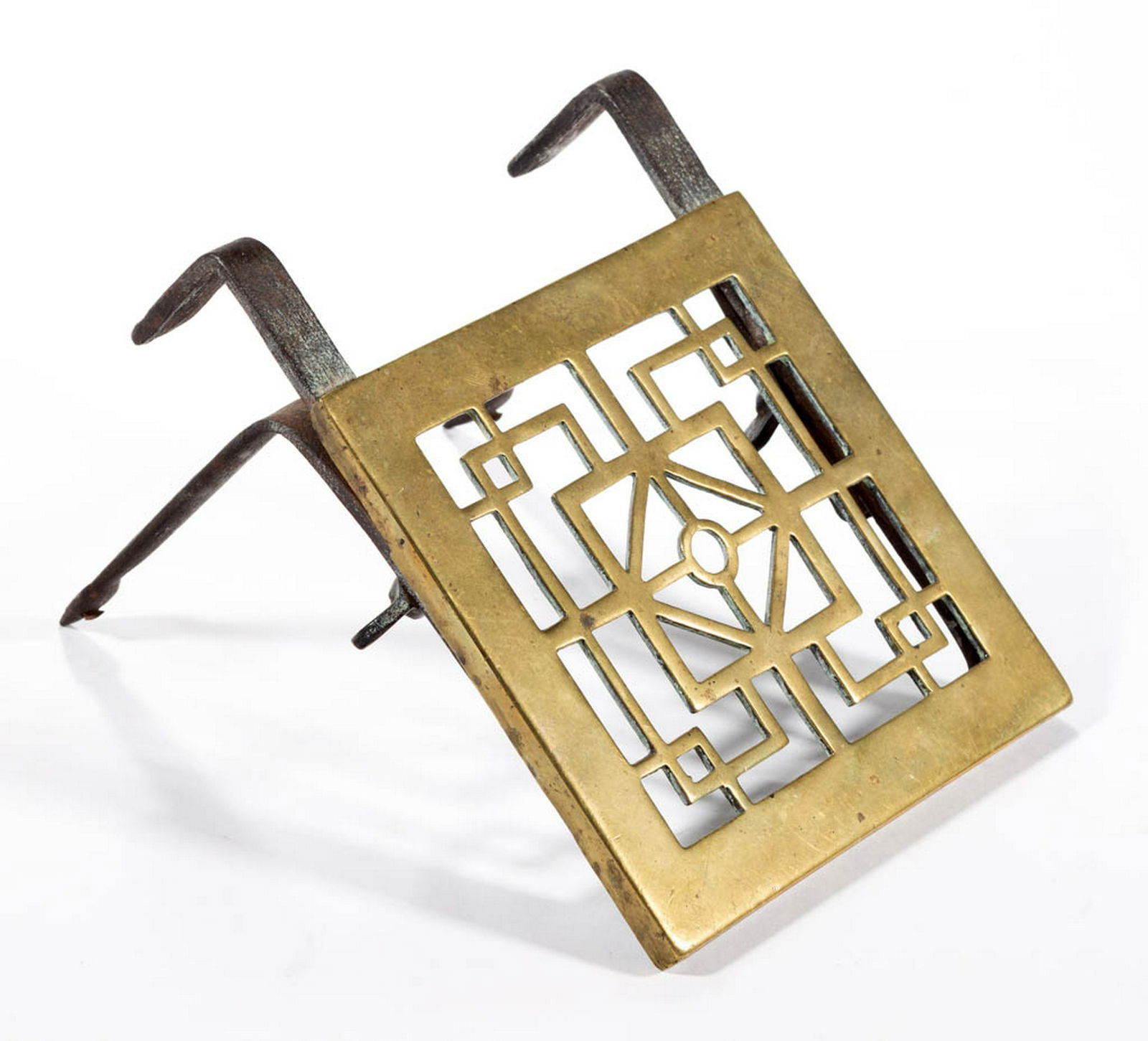 ENGLISH BRASS HEARTH TRIVET: ENGLISH BRASS HEARTH TRIVET, having hand-forged iron adjustable legs and wing nuts, iron brackets for attaching to fireplace fender. Mid/second half 18th century. 7" x 5 3/8" x 5" OA.Very good overall