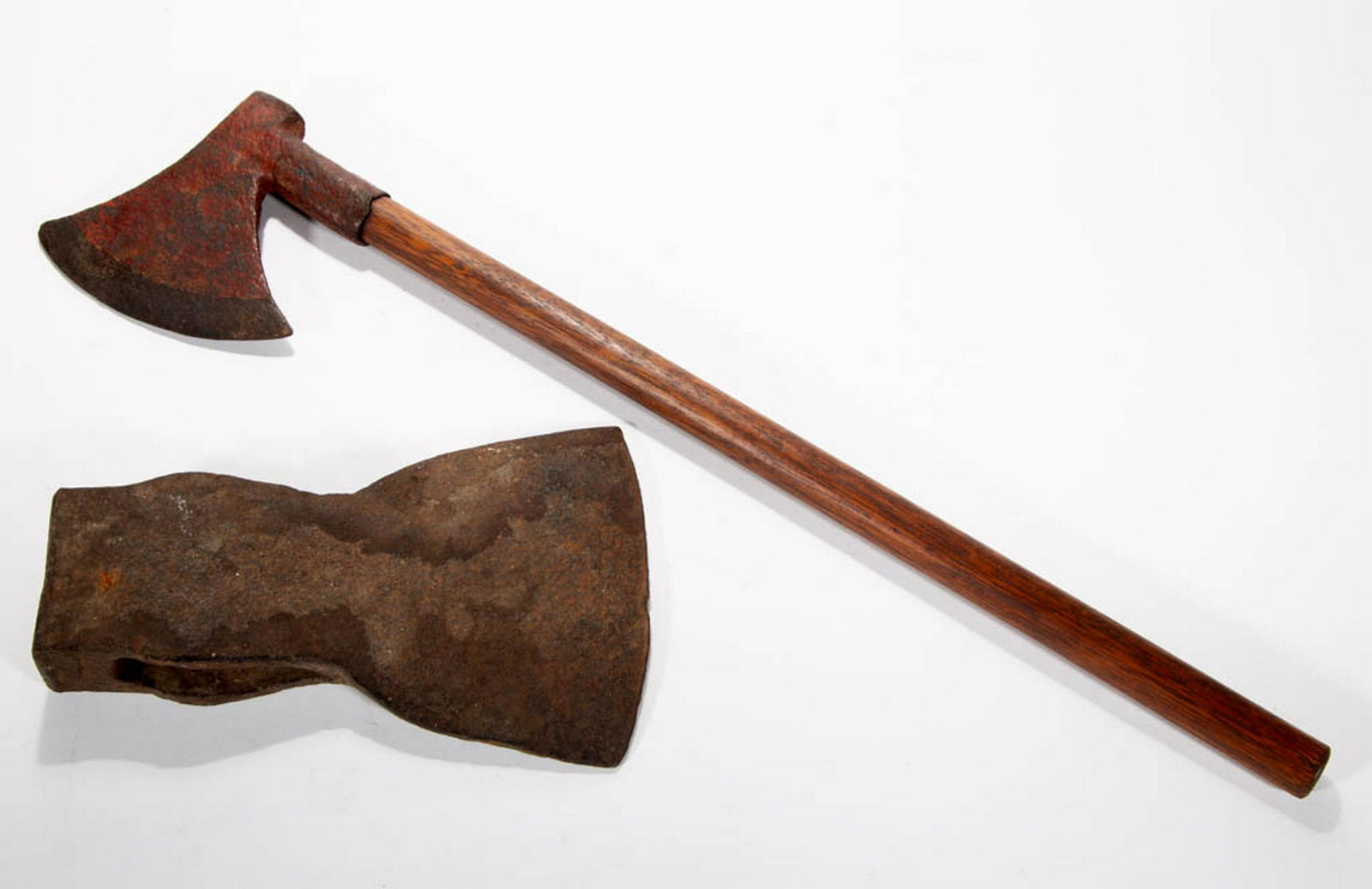 ASSORTED AMERICAN WROUGHT IRON AXES, LOT OF TWO: ASSORTED AMERICAN WROUGHT IRON AXES, LOT OF TWO, each hand-forged. One retains traces of an old red-painted surface. 19th century. Axe with handle 23" LOA.Trade ax with old crack and replaced handle,