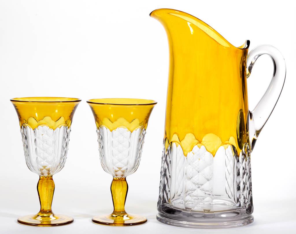 ADORIA - AMBER-STAINED DRINKING ARTICLES, LOT OF THREE: ADORIA - AMBER-STAINED DRINKING ARTICLES, LOT OF THREE, colorless, comprising a pitcher with applied handle and a pair of goblets. Co-Operative Flint Glass Co. Pattern introduced 1922. Pitcher 10 7/8"