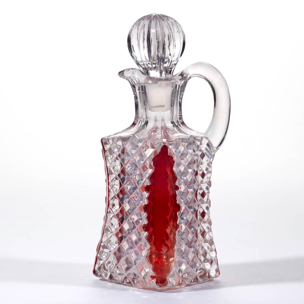 FOSTORIA'S LORRAINE / FLAT DIAMOND BOX - RUBY-STAINED: FOSTORIA'S LORRAINE / FLAT DIAMOND BOX - RUBY-STAINED CRUET, colorless, pressed-ribbed stopper, cut-and-shut scar under the base. Circa 1893. 7 1/8" HOA. Cruet undamaged; stopper having a couple of mi