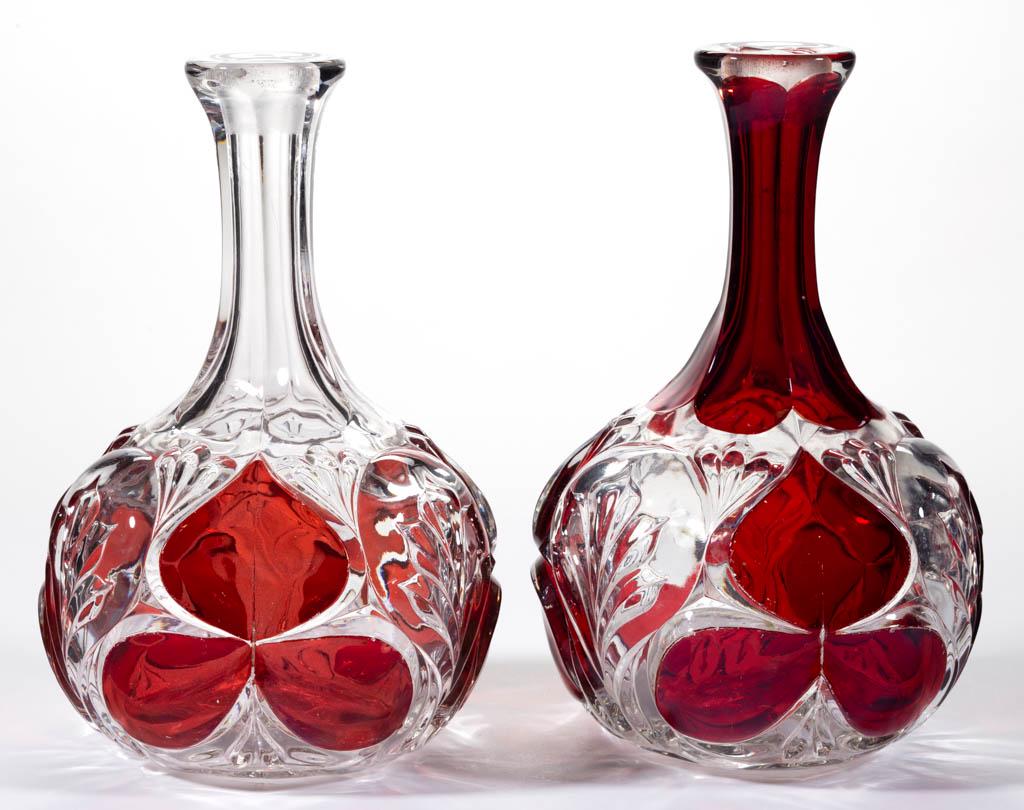 MURANO - RUBY-STAINED WINE DECANTERS, LOT OF TWO: MURANO - RUBY-STAINED WINE DECANTERS, LOT OF TWO, colorless, each with a cut-and-shut mark under the base. Greensburg Glass Co. Pattern introduced in 1894. 8 1/2" to 8 3/4" H.Each in excellent conditi
