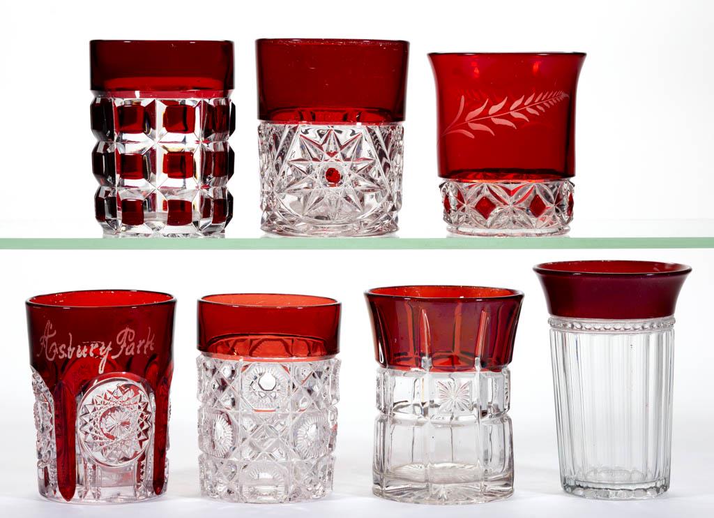 ASSORTED EAPG - RUBY-STAINED TUMBLERS, LOT OF SEVEN: ASSORTED EAPG - RUBY-STAINED TUMBLERS, LOT OF SEVEN, colorless, including a Tarentum's Verona, a Robinson's Puritan, a Duncan Late Block, and a McKee No. 700. Various makers. Fourth quarter 19th/first