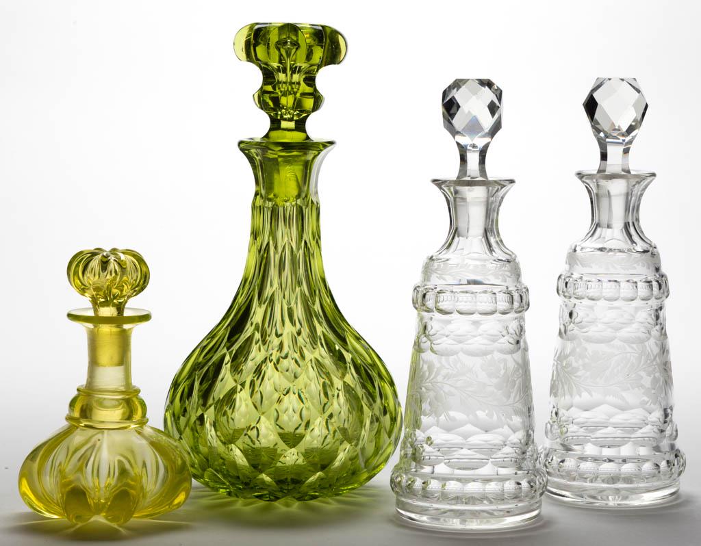 ASSORTED MOLDED AND CUT COLOGNE BOTTLES / DECANTERS,: ASSORTED MOLDED AND CUT COLOGNE BOTTLES / DECANTERS, LOT OF FOUR, comprising a canary yellow (reacts under black light) Pillar-Molded cologne with applied convex neck ring, a yellow-green elliptical c