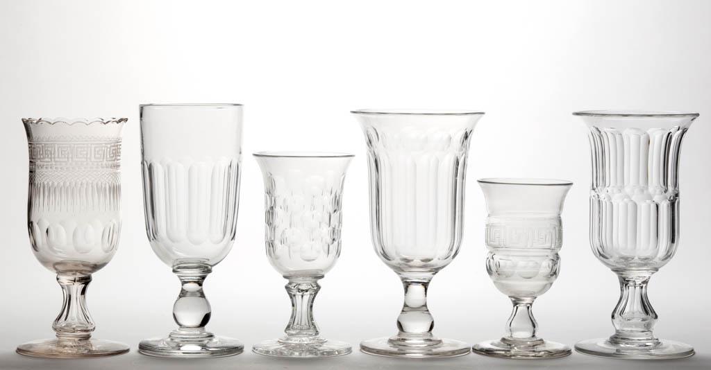 ASSORTED CUT FLINT CELERY VASES, LOT OF FIVE: ASSORTED CUT FLINT CELERY VASES, LOT OF FIVE, colorless lead glass, including one with a scalloped rim and a Greek key band and one with 14 panels. Together with a blown molded celery vase with a Gree
