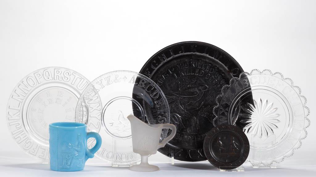 ASSORTED GLASS AND TIN CHILDREN'S TOYS, LOT OF SEVEN: ASSORTED GLASS AND TIN CHILDREN'S TOYS, LOT OF SEVEN, comprising an opaque powder blue Alphabet and Children mug, frosted colorless Lion creamer, three colorless ABC plates, one with frosted center, a