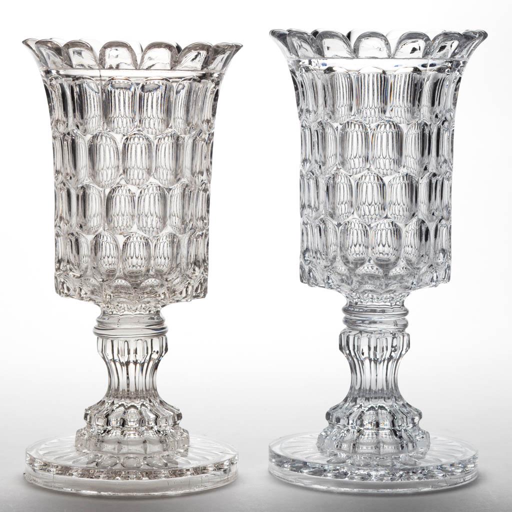 EARLY THUMBPRINT / ARGUS (OMN) CELERY VASES, LOT OF TWO: EARLY THUMBPRINT / ARGUS (OMN) CELERY VASES, LOT OF TWO, colorless lead glass, wafer construction. Bakewell, Pears & Co., Pittsburgh, PA. Third quarter 19th century.9 1/4" and 9 1/2" H. Each in excell