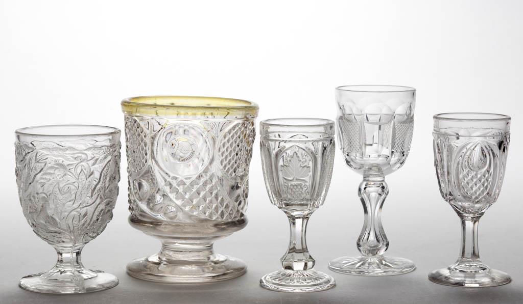 ASSORTED FLINT EAPG ARTICLES, LOT OF FOUR: ASSORTED FLINT EAPG ARTICLES, LOT OF FOUR, colorless lead glass, including a Morning Glory egg cup, New England Pineapple wine, Magnet and Grape wine, and a Horn of Plenty spooner. Together with a cut