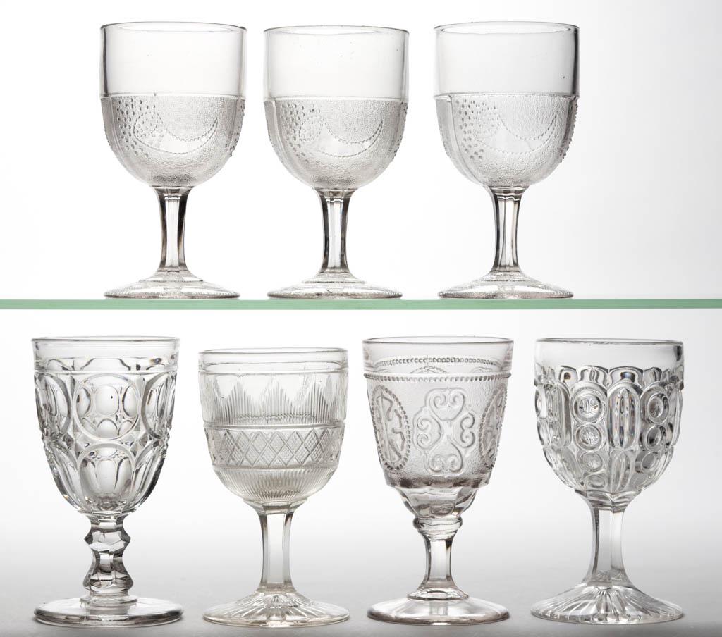 ASSORTED FLINT EAPG GOBLETS, LOT OF SEVEN: ASSORTED FLINT EAPG GOBLETS, LOT OF SEVEN, colorless lead glass, including three Powder and Shot, one Excelsior with Maltese Cross, and one Hamilton. Third quarter 19th century.6" to 6 1/4" H. Six und